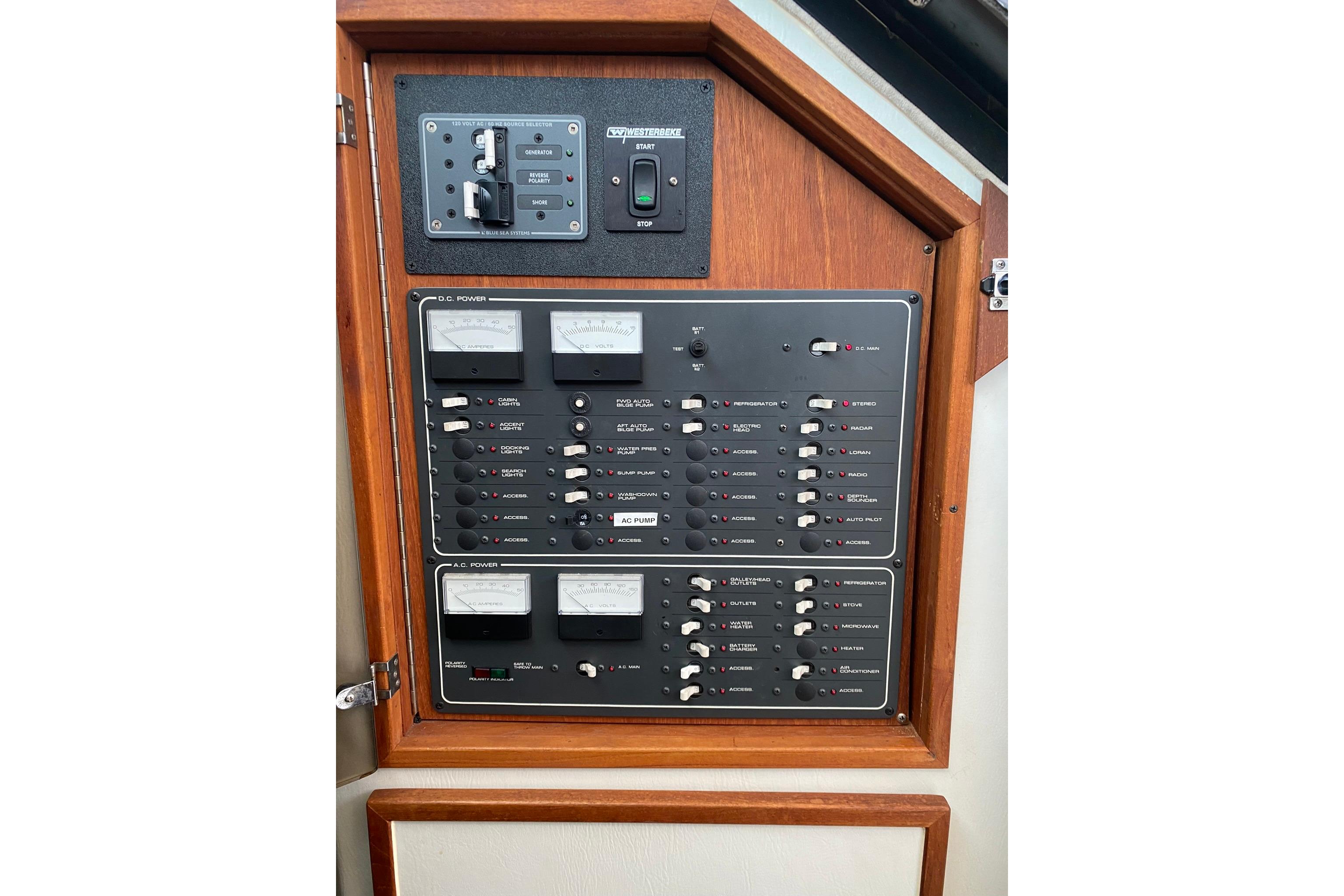 Electrical control panel on a 1988 Tiara 3300 Open boat, featuring switches and gauges.