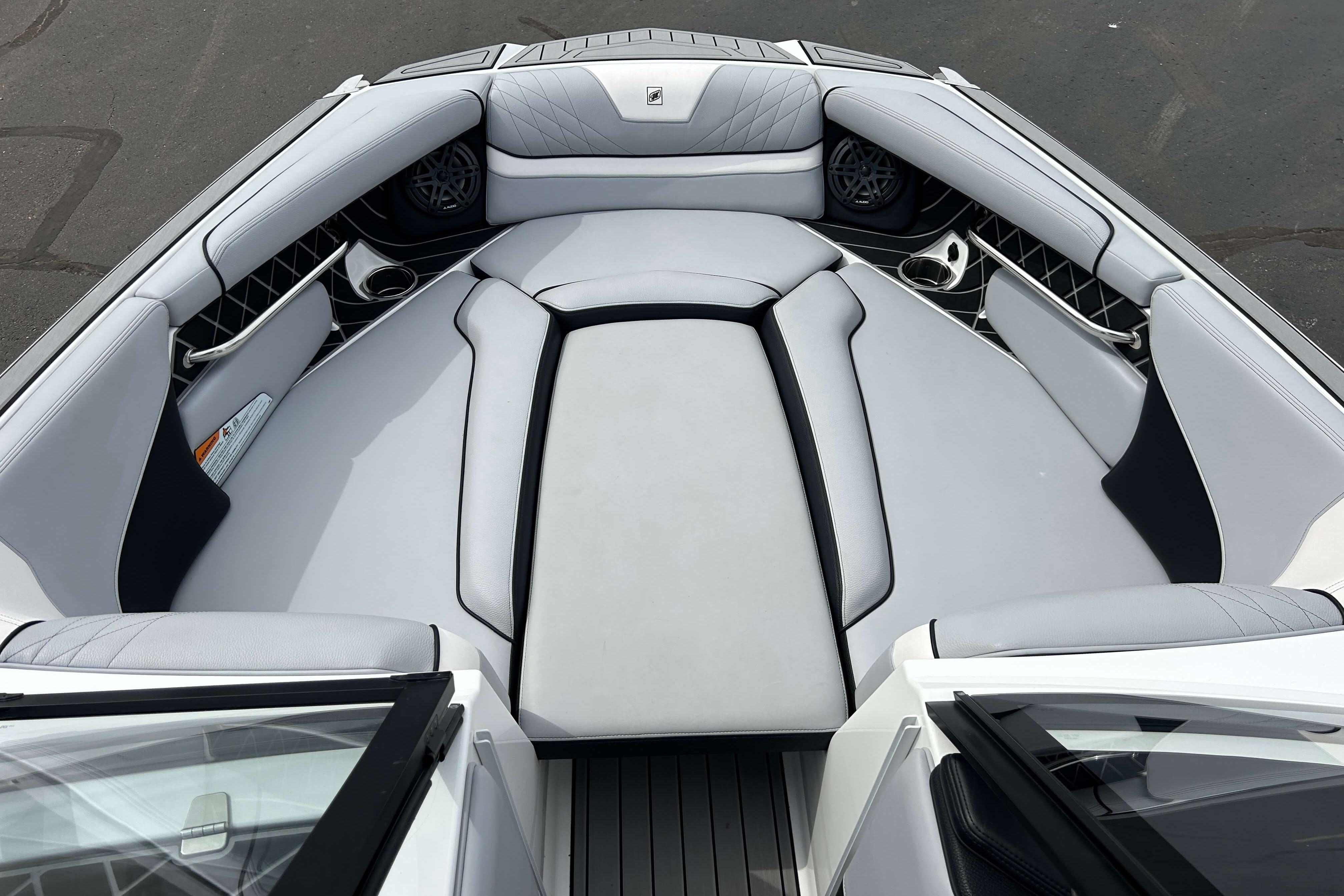 2021 Nautique Super Air Nautique GS24 boat interior with luxurious seating and cup holders.