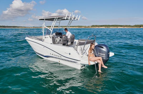 2023 Jeanneau Leader 6.5 CC S3 boat on water with people enjoying.