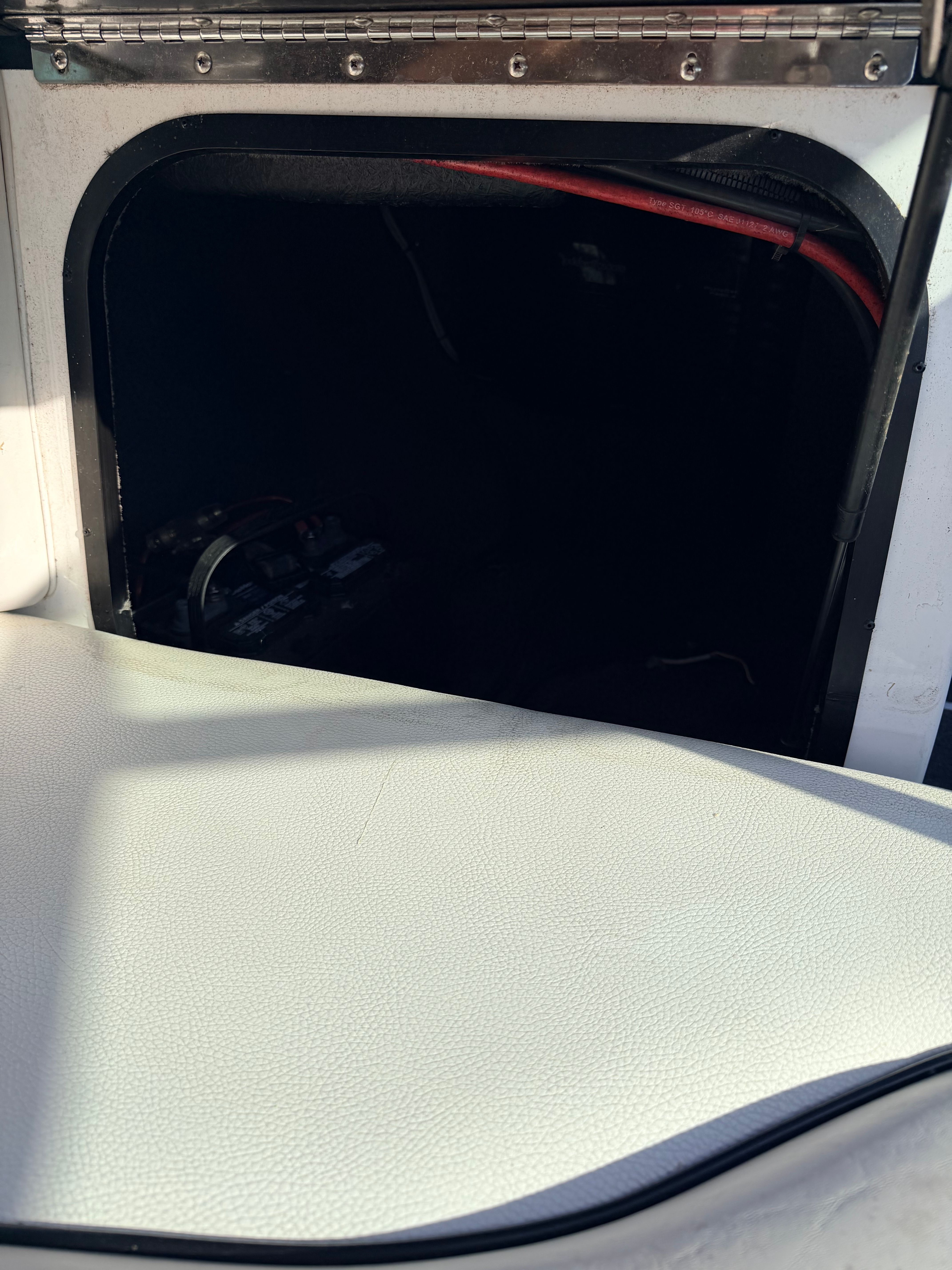 Interior of a 2006 Malibu iRide boat with storage compartment.