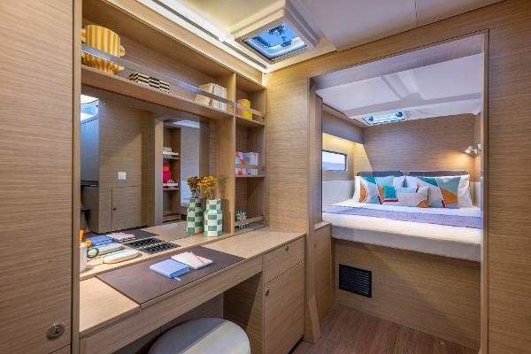 Luxurious interior of 2025 Lagoon 38 yacht with modern decor and cozy bedroom.