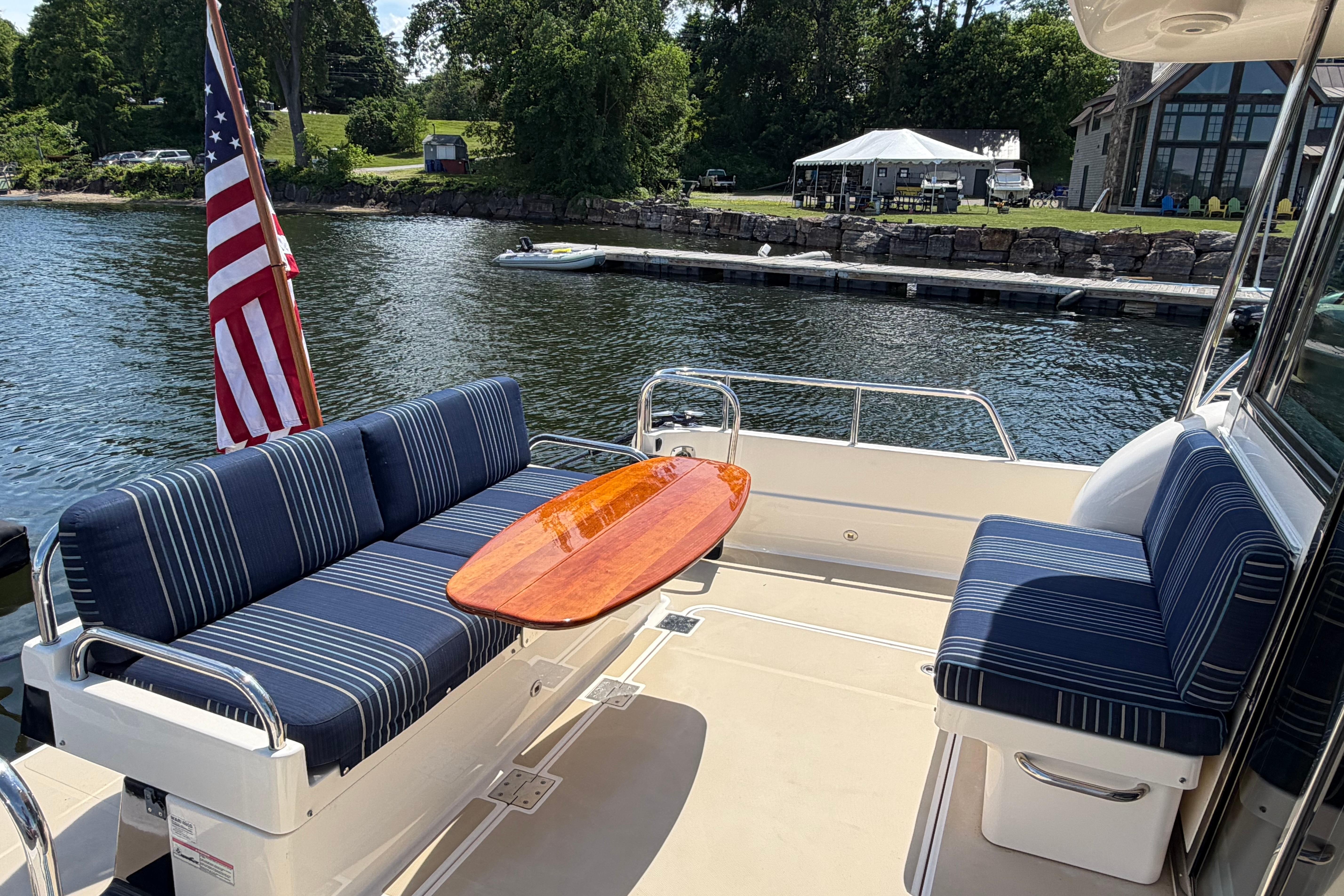 2015 Sabre 38 Salon Express yacht deck with striped seating and American flag.