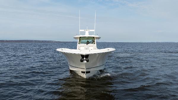 2025 Scout 425 LXF boat cruising on open water under a clear sky.
