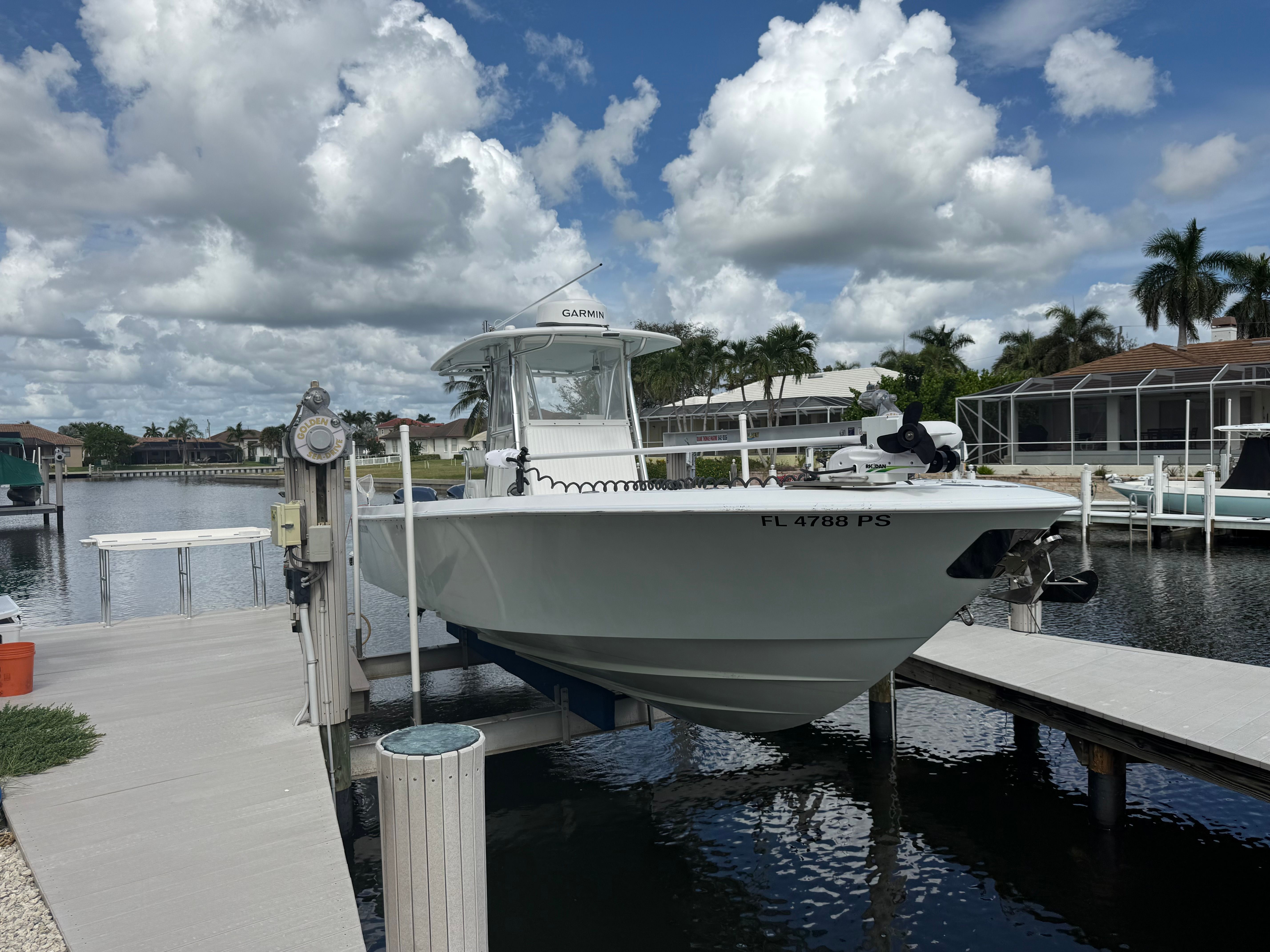2012 Contender 32 ST boat docked under cloudy sky.
