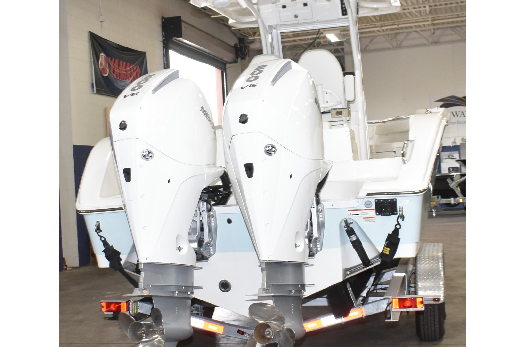 2025 Sea Pro 262 Offshore boat with dual outboard engines in a showroom.