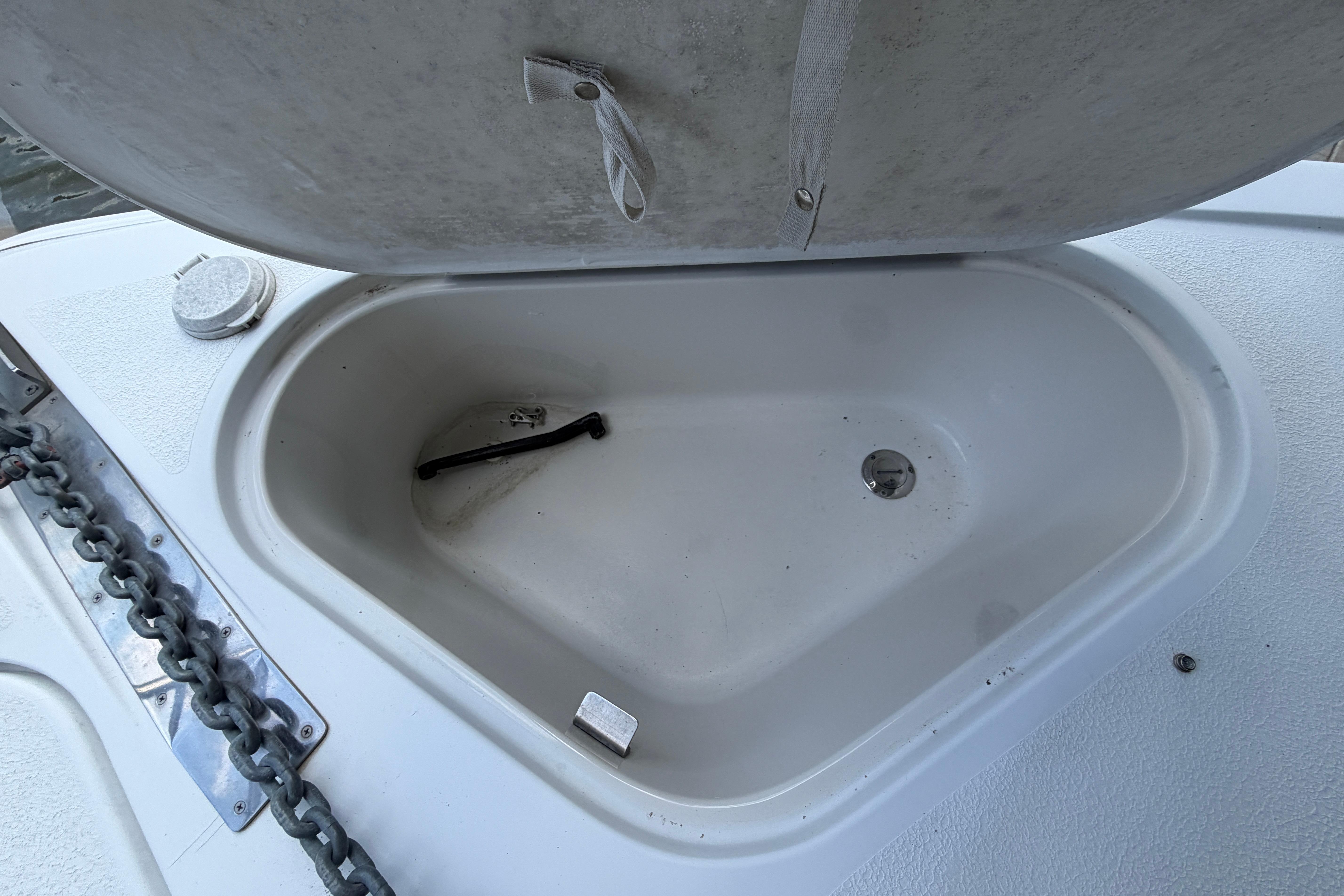 Open storage compartment on a 2000 Carver 350 Mariner boat deck.