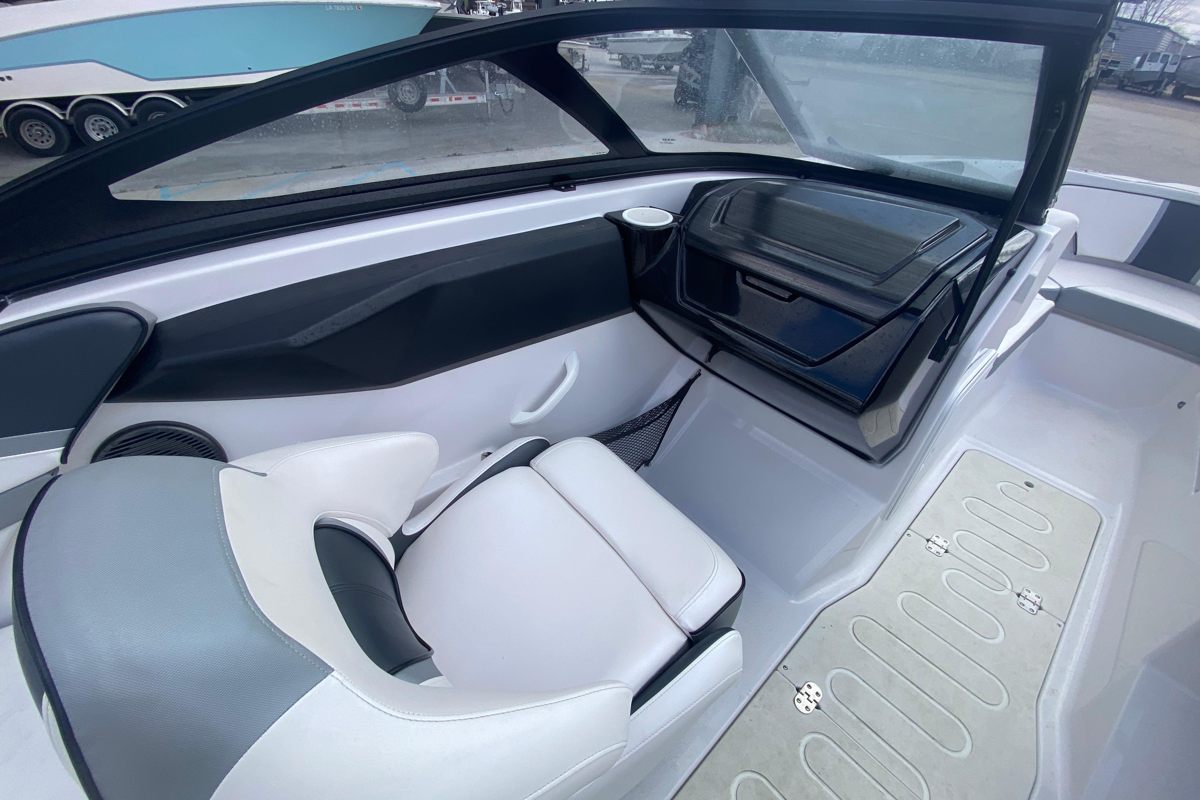 2018 Scarab 215 G boat interior with white seating and modern dashboard design.