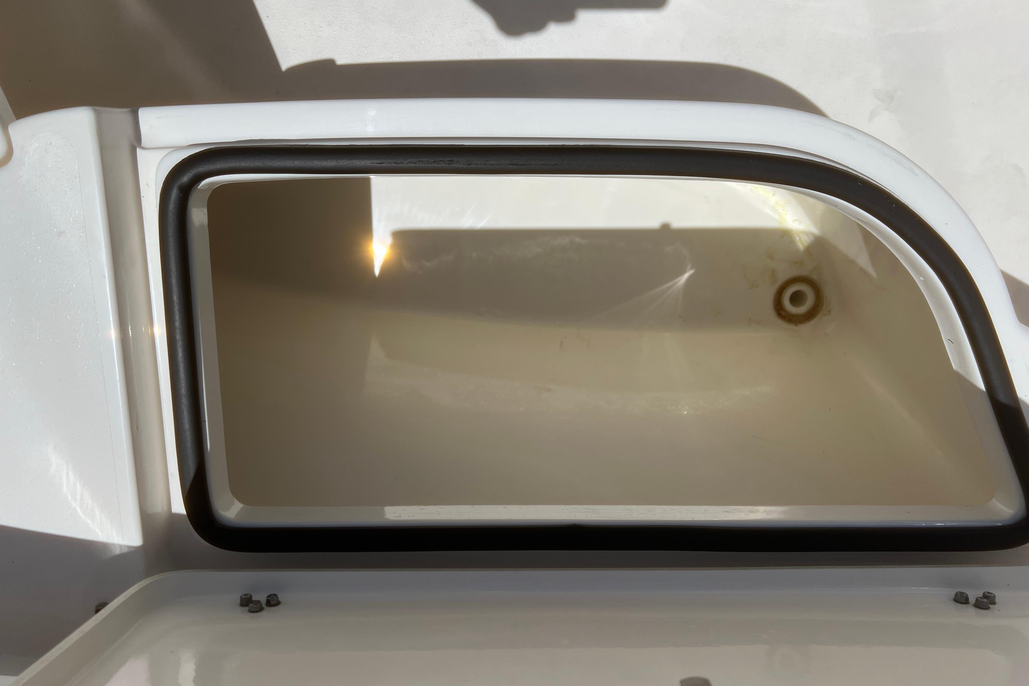 Open storage compartment on 2018 Cobia 201 Center Console boat.