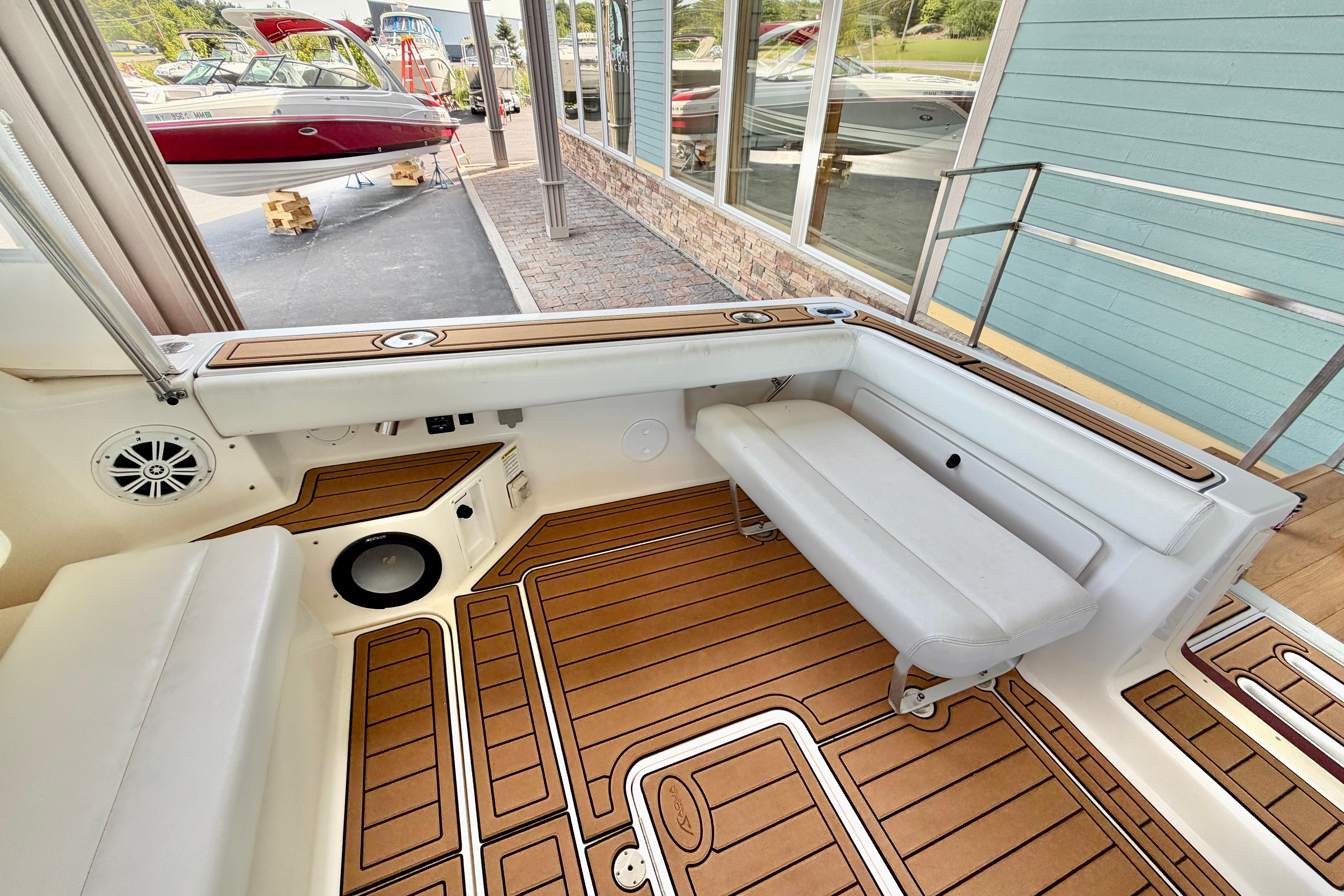 1999 Tiara Yachts 2900 Coronet interior with teak flooring and white seating.