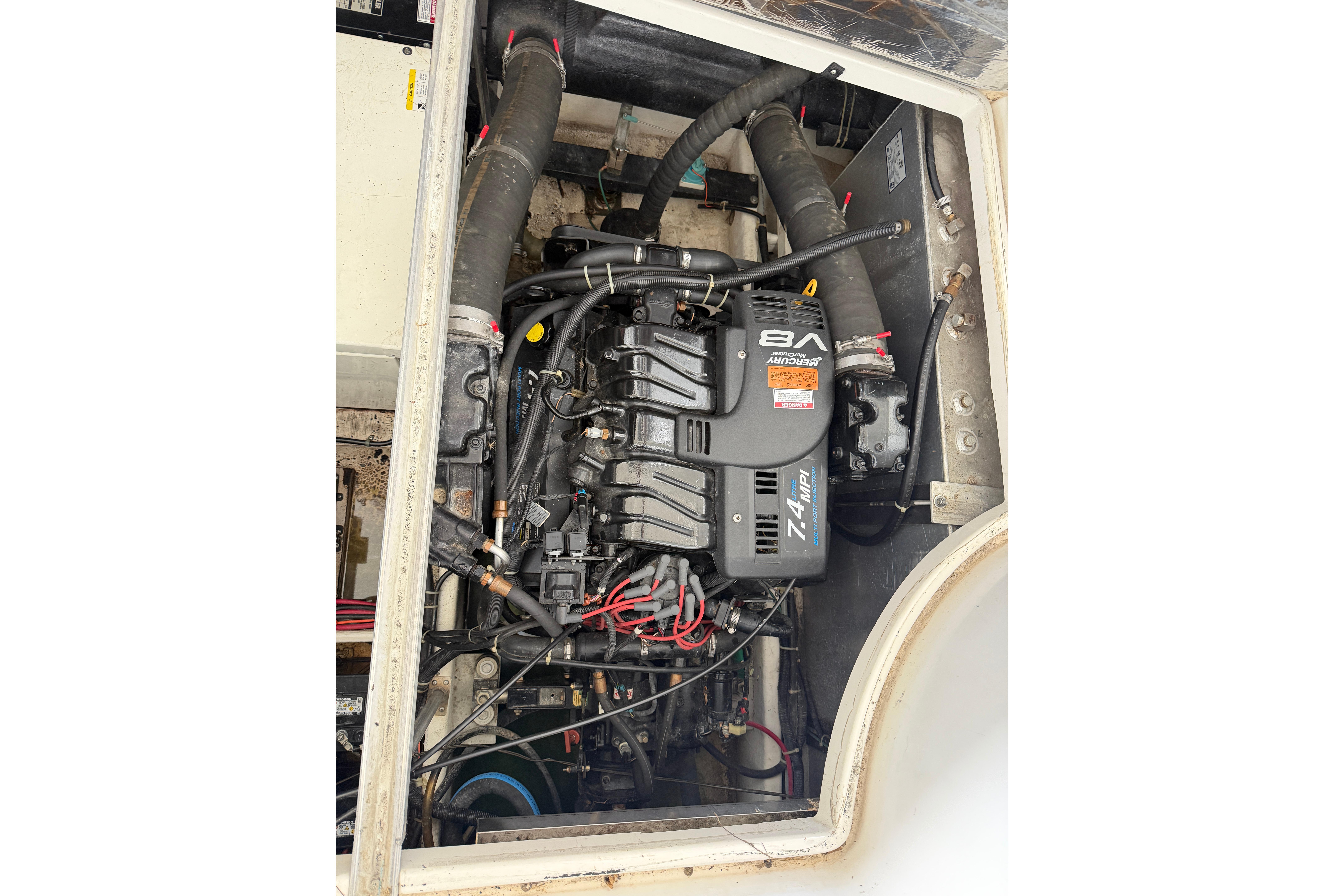 Engine compartment of a 2000 Carver 350 Mariner boat, featuring a V8 engine.