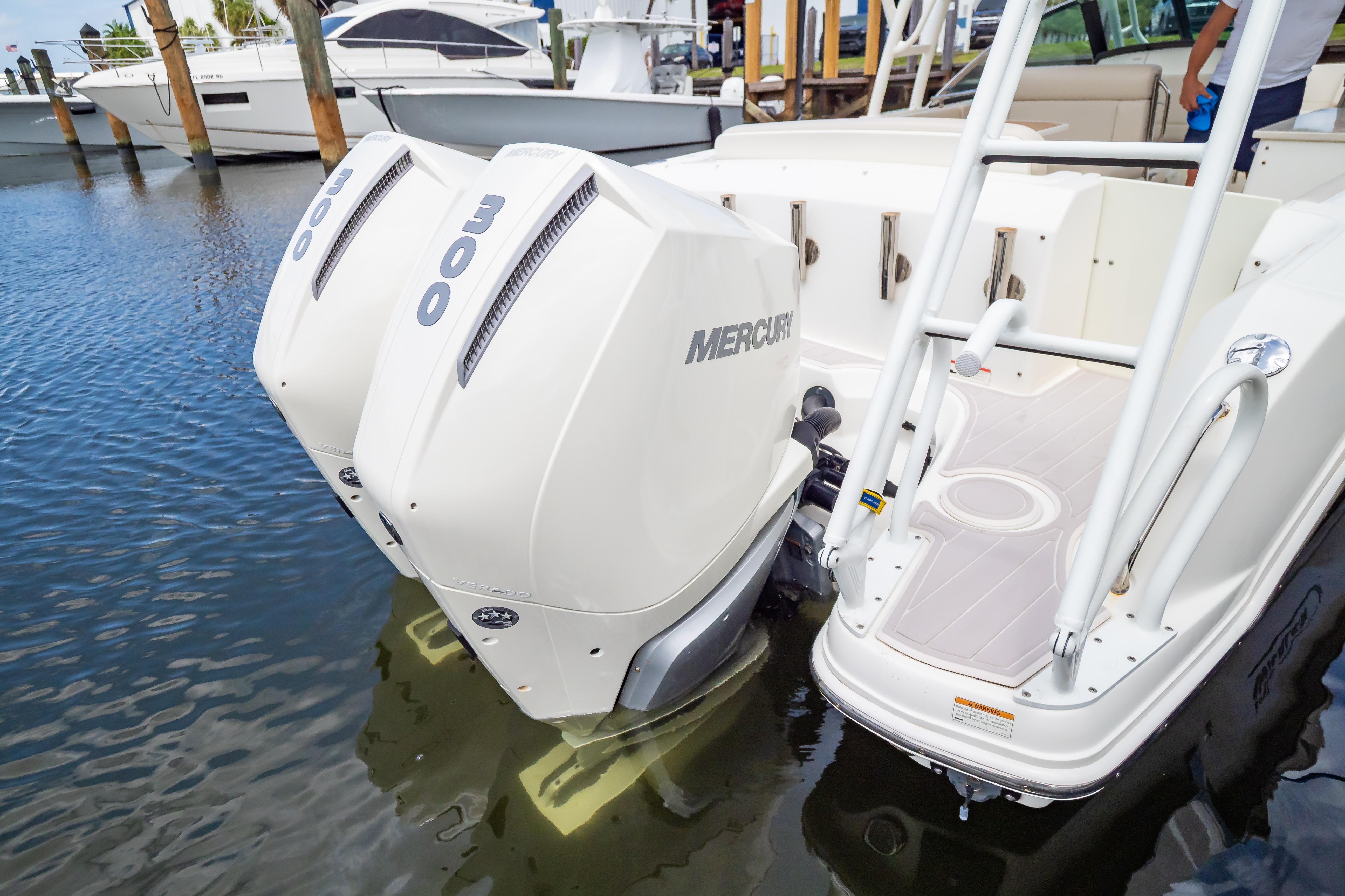 2019 Boston Whaler 270 Vantage with twin Mercury 300 engines docked in marina.