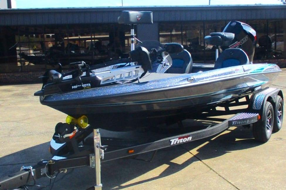 2026 Triton 18 TrX boat on trailer, parked outdoors, featuring sleek design and modern equipment.