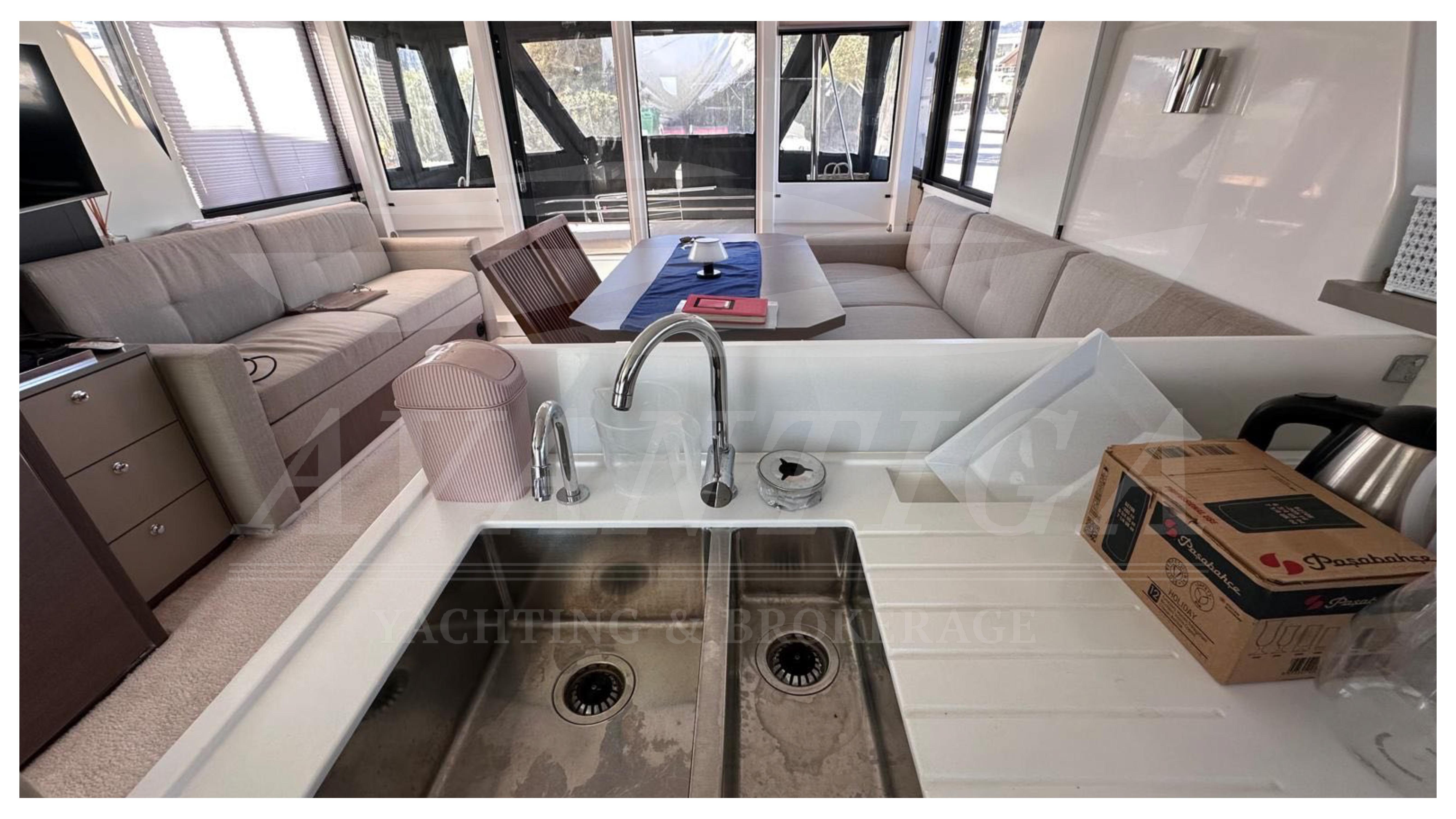 Luxurious Bali 4.2 yacht interior with modern kitchen and spacious seating area, 2021 model.
