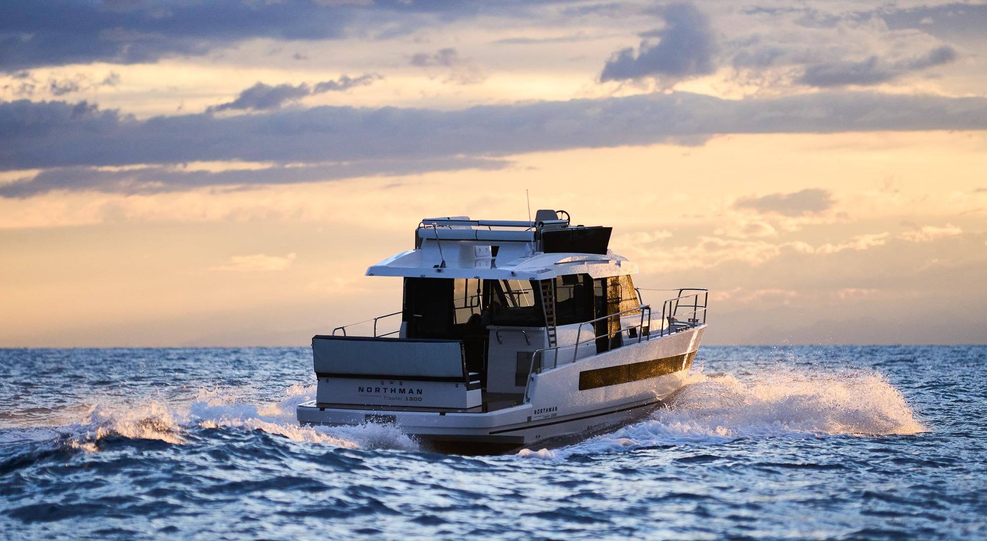 2025 Northman 1300 yacht cruising at sunset on open sea.