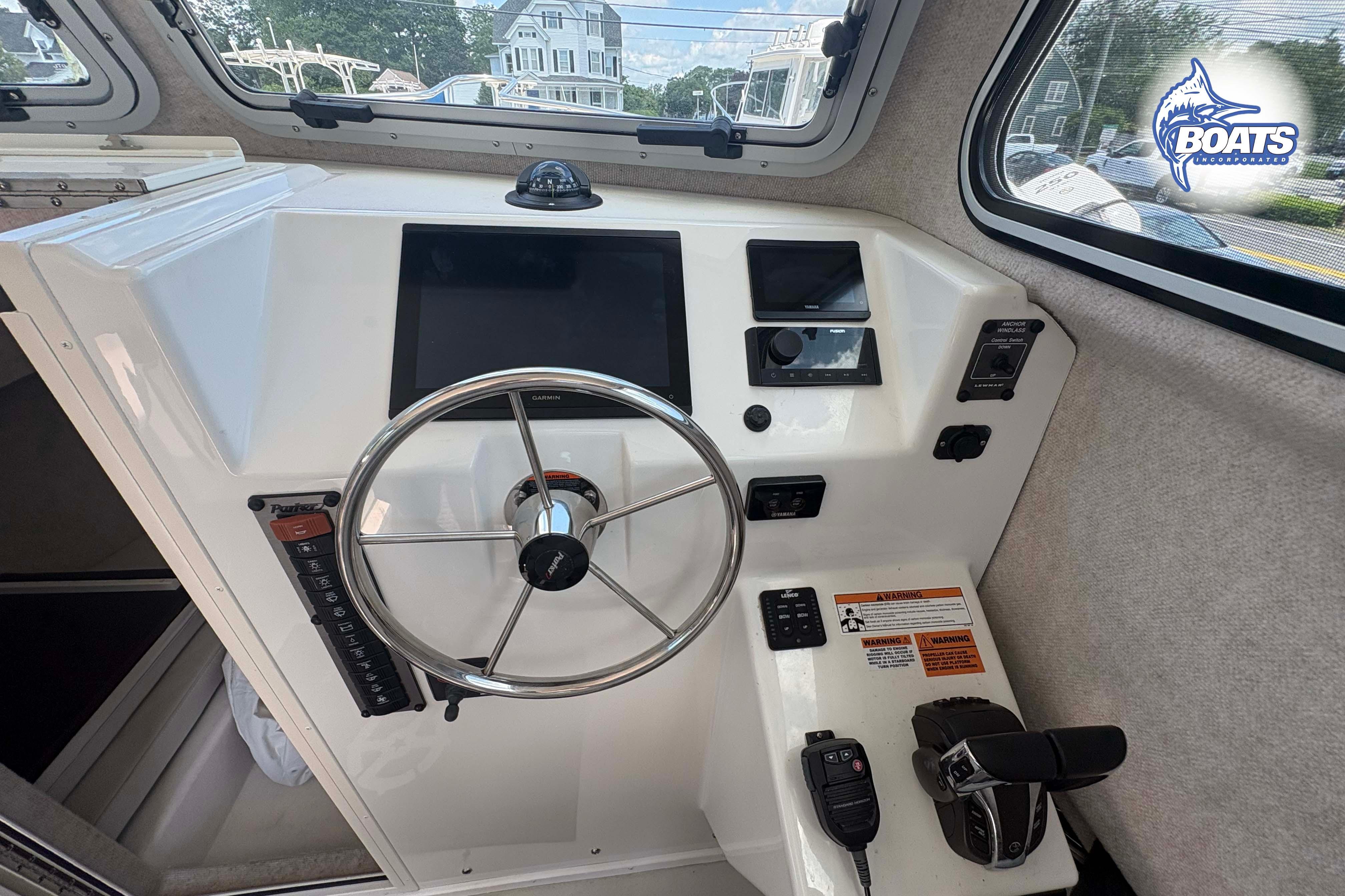 Helm of 2021 Parker 2520 XLD Sport Cabin with steering wheel and controls.