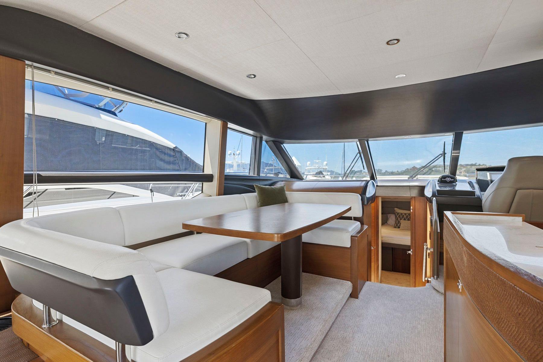 Luxurious interior of 2015 Princess 60 Flybridge Motor Yacht with elegant seating and panoramic windows.