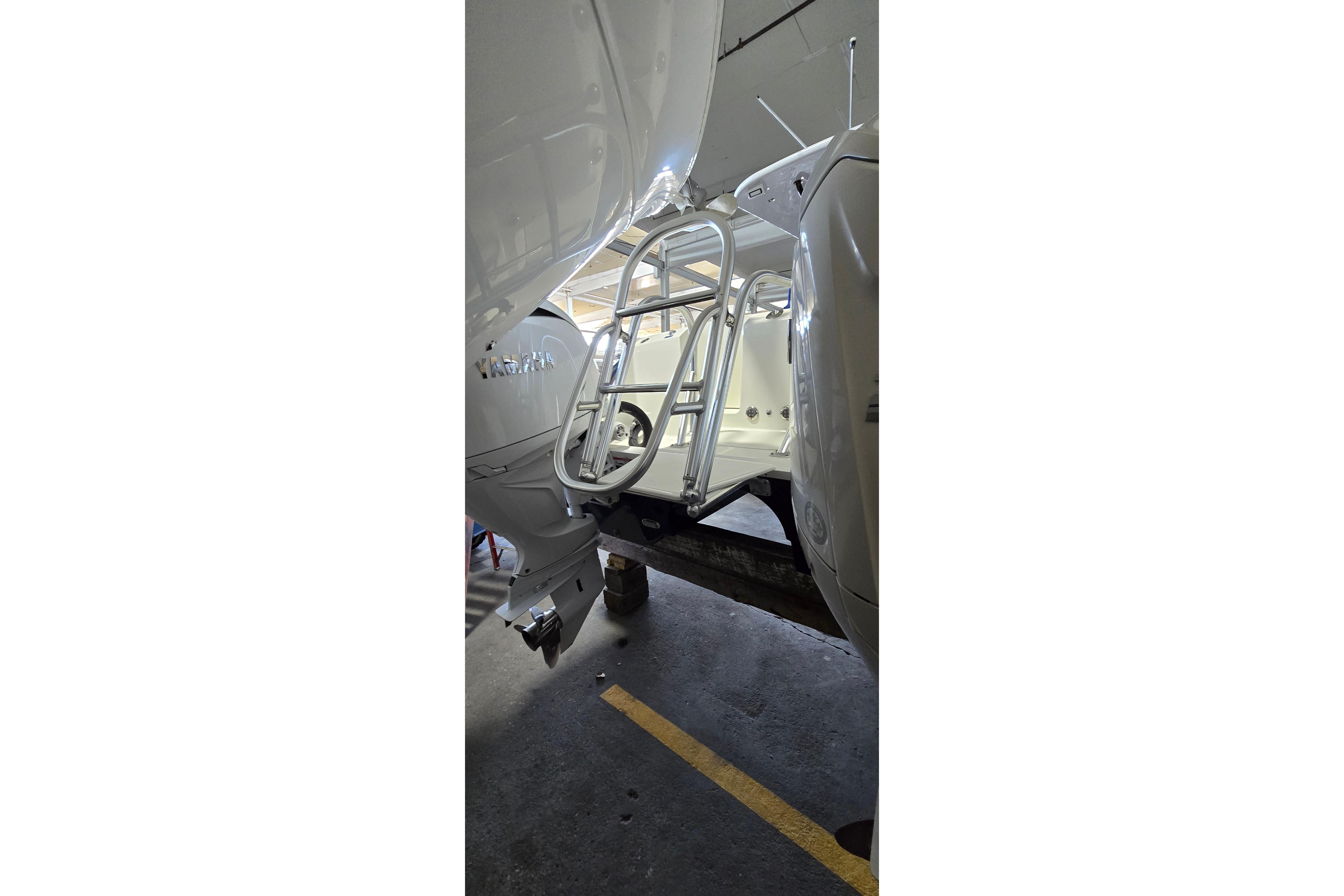 2024 WorldCat 280 CC-X boat with ladder in a garage setting.