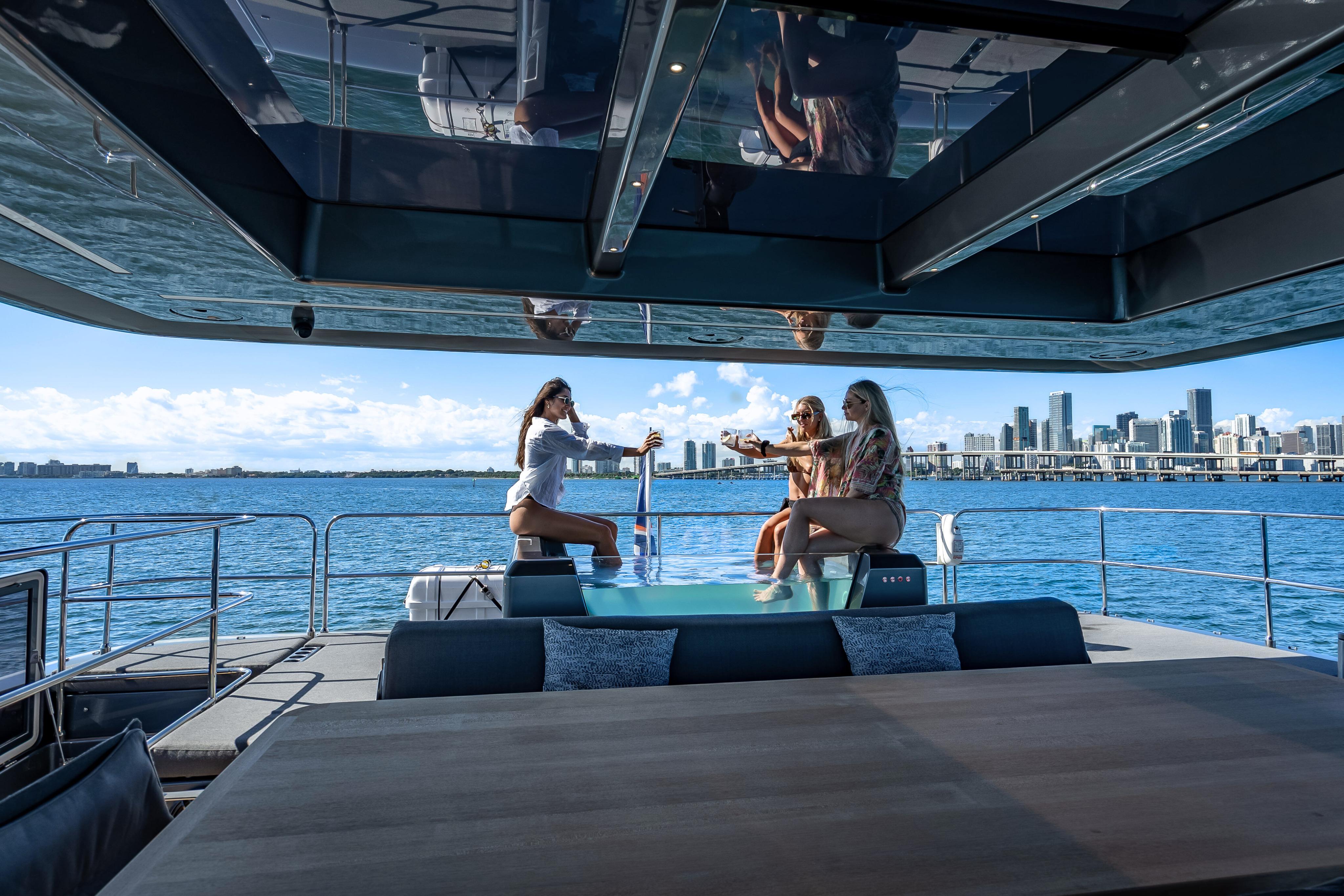 Luxurious Sunreef 60 Power yacht with people enjoying the deck, city skyline in background, 2026 model.