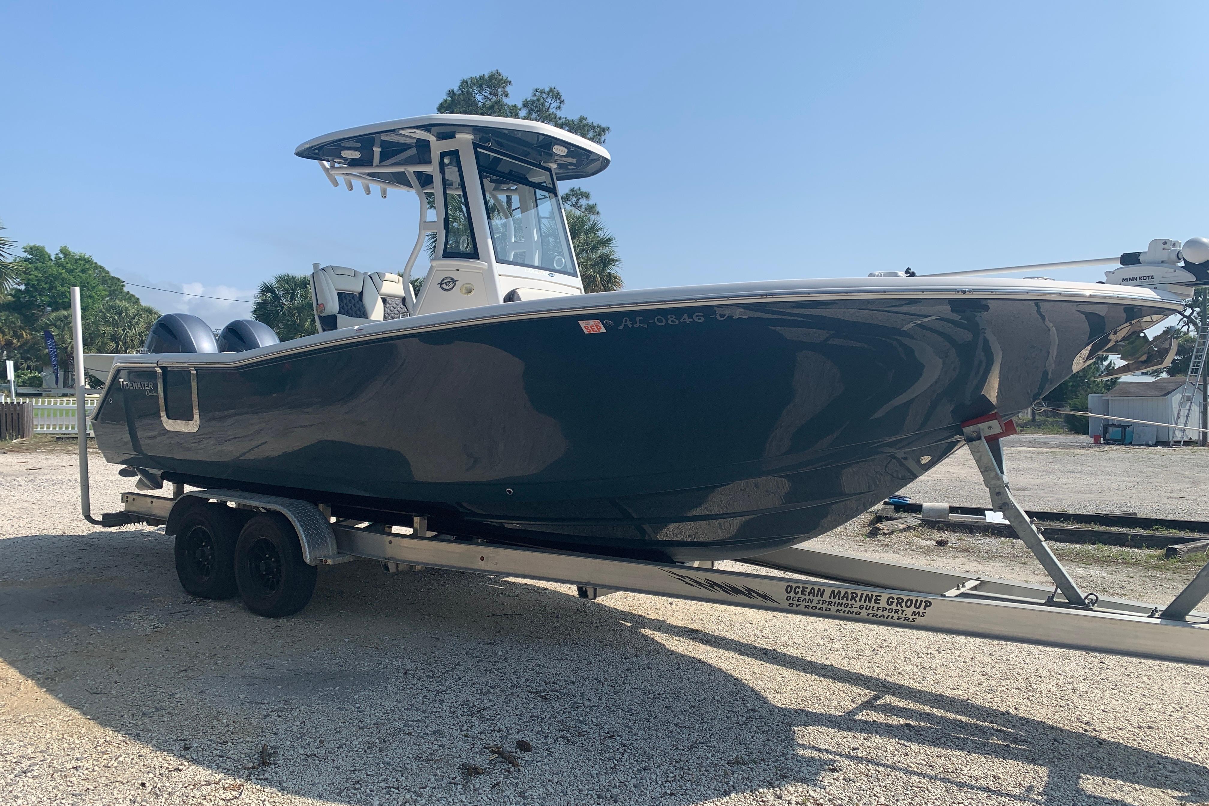 2021 Tidewater 256 CC Adventure boat on trailer, parked outdoors.
