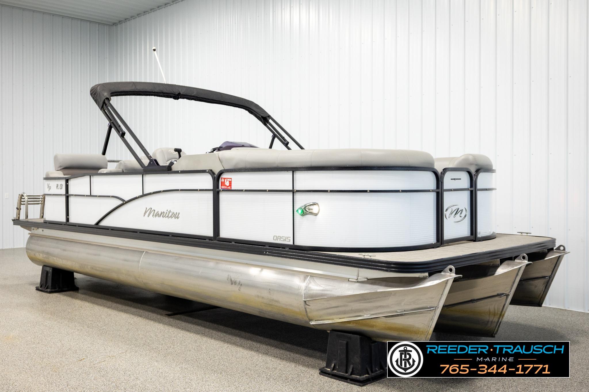 2019 Manitou Oasis SR VP pontoon boat in showroom, featuring sleek design and modern amenities.