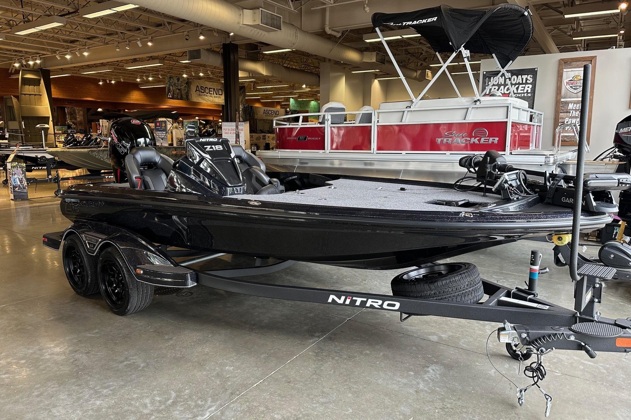 2026 Nitro Z18 Pro boat displayed in showroom, sleek black design, dual-axle trailer.
