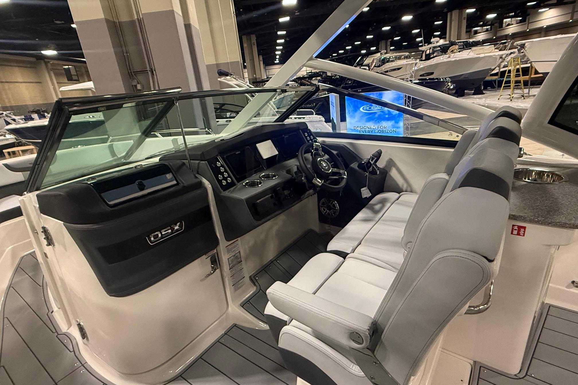 2026 Chaparral 280 OSX boat interior with modern dashboard and seating at a boat show.