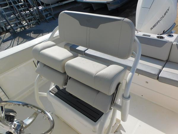 2025 Sailfish 232 CC boat seating with white cushioned helm chairs and steering wheel.