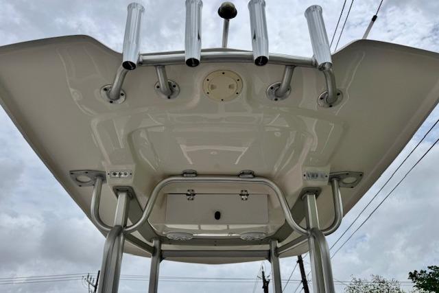 2015 Robalo 226 Cayman boat top view with rod holders and canopy.