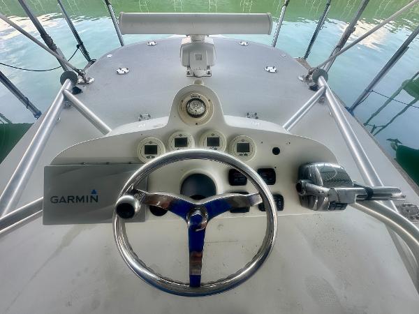 2008 SeaVee 390B boat helm with Garmin navigation system and steering wheel.