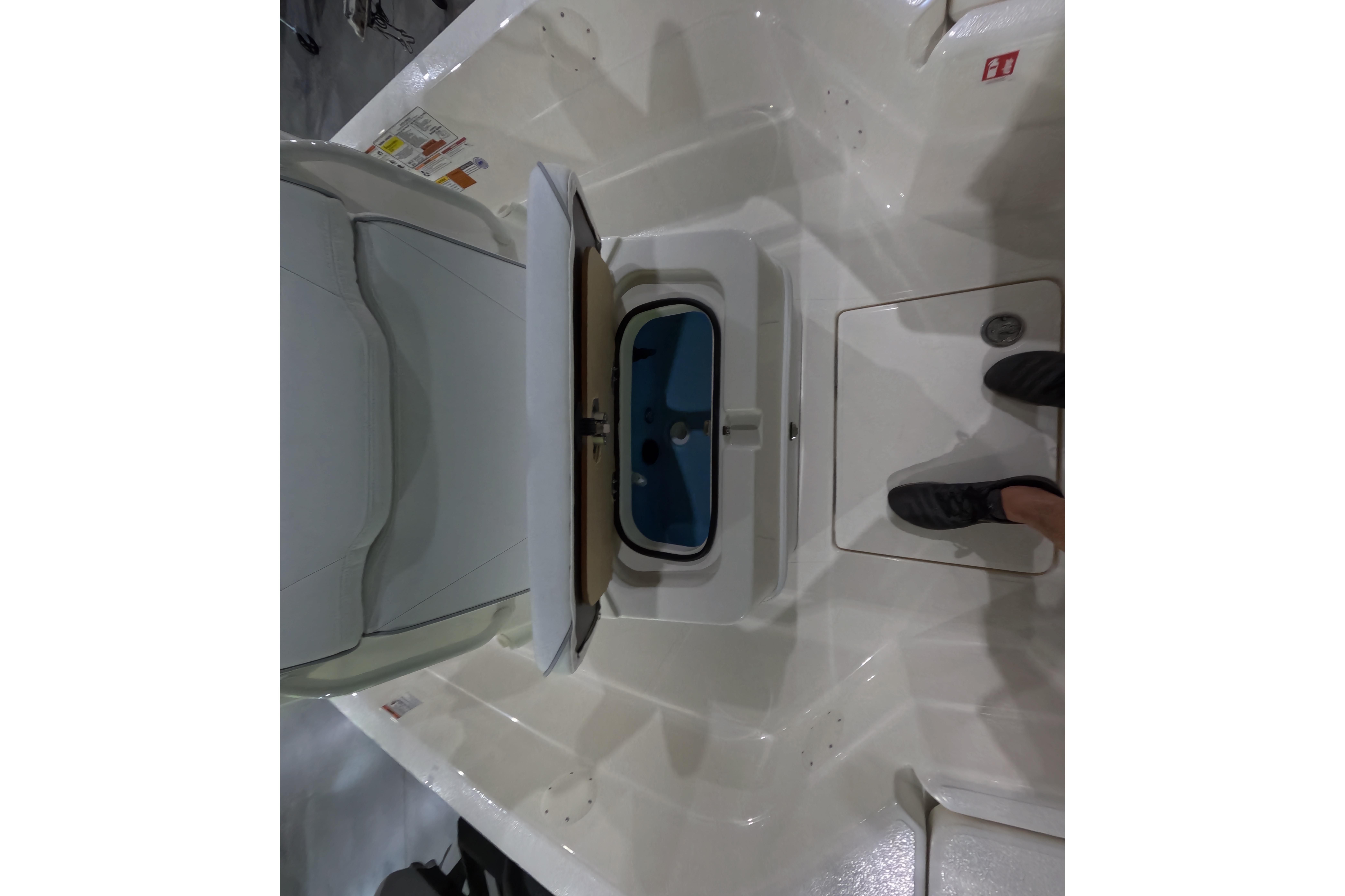 2026 Skeeter SX221 boat interior with open storage compartment and seating area.