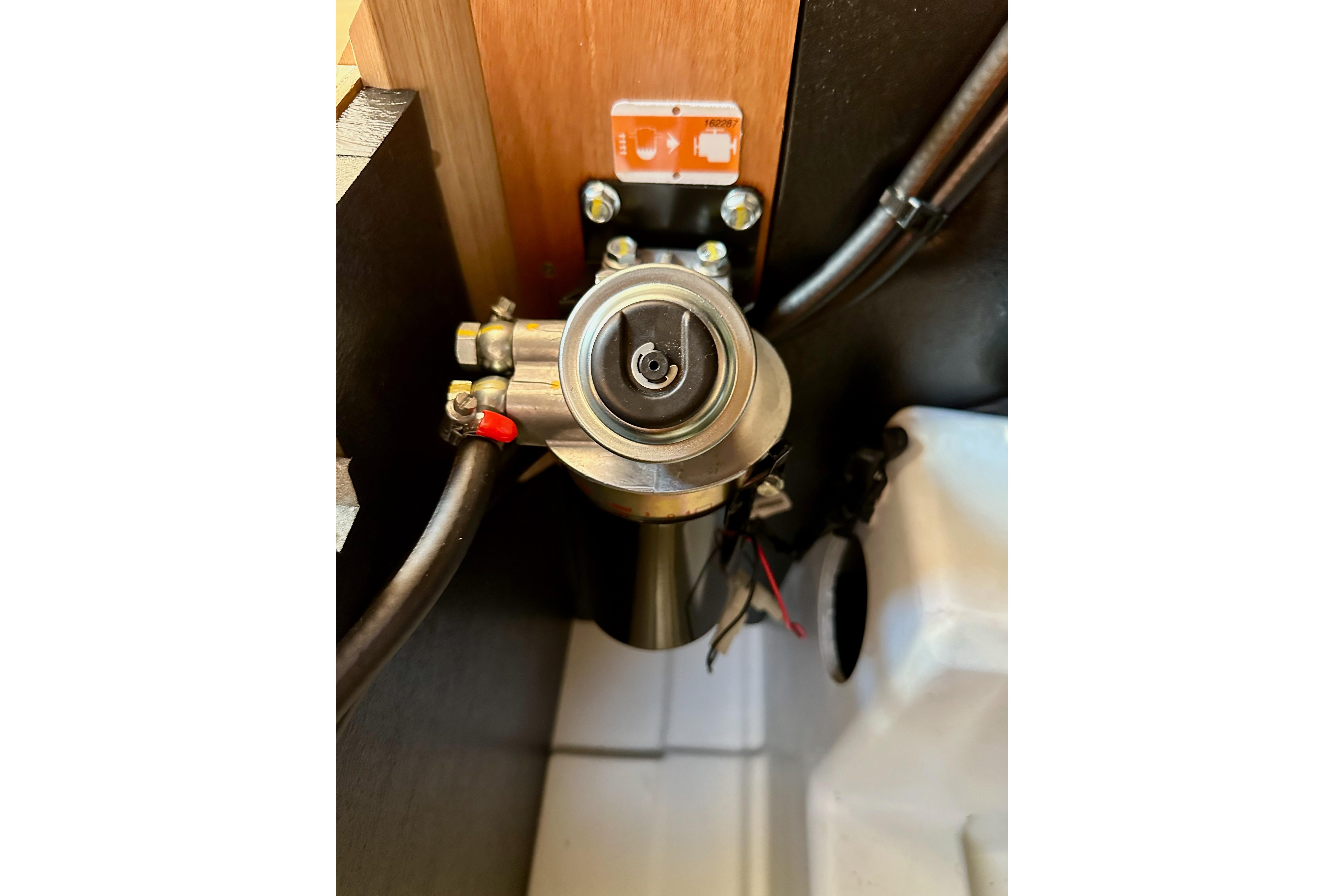 Engine component of 2024 Jeanneau Sun Odyssey 410 sailboat, showcasing intricate mechanical details.
