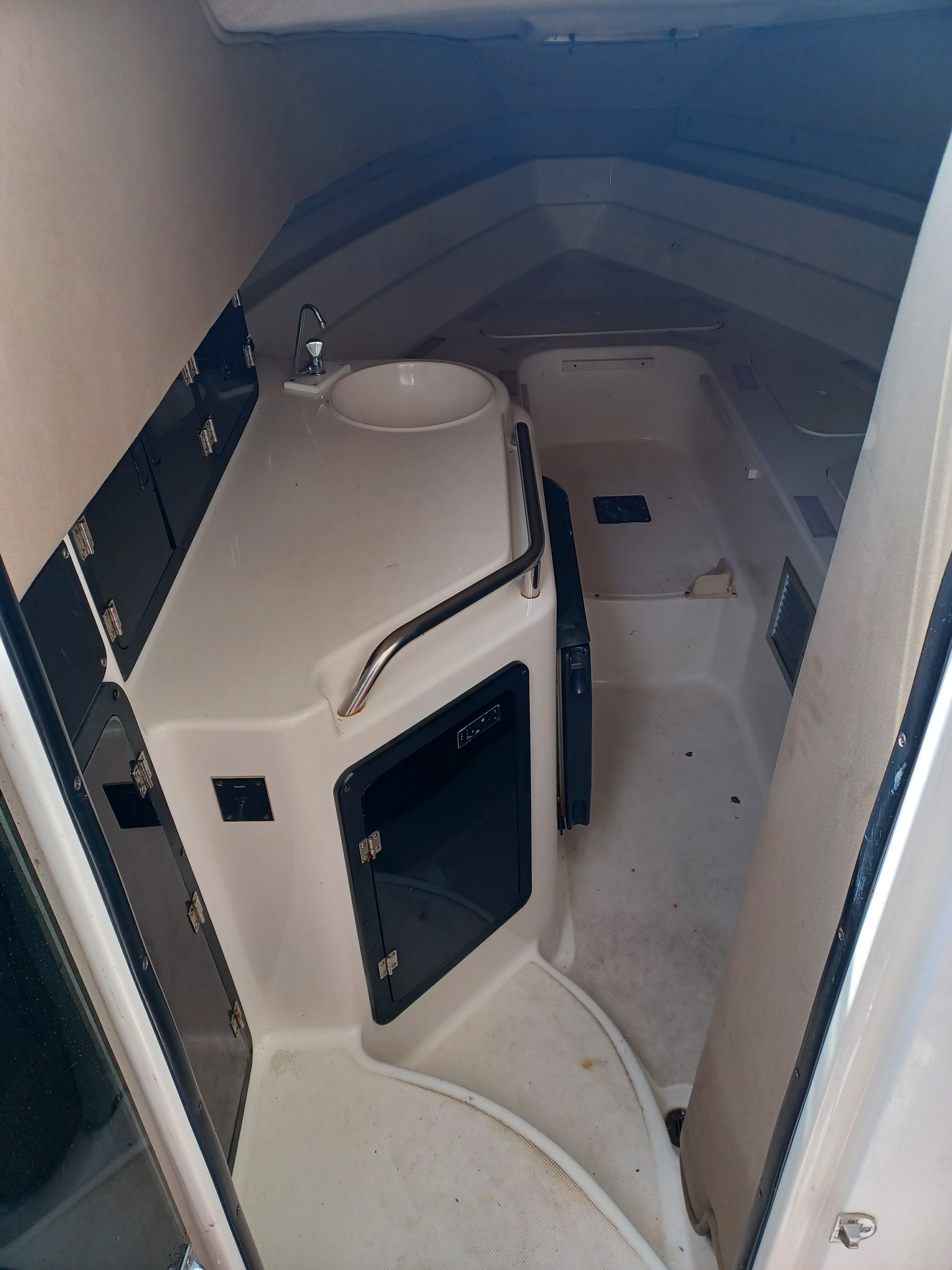 Interior of a 1995 Fountain 31 SFC with a sink and storage compartments.