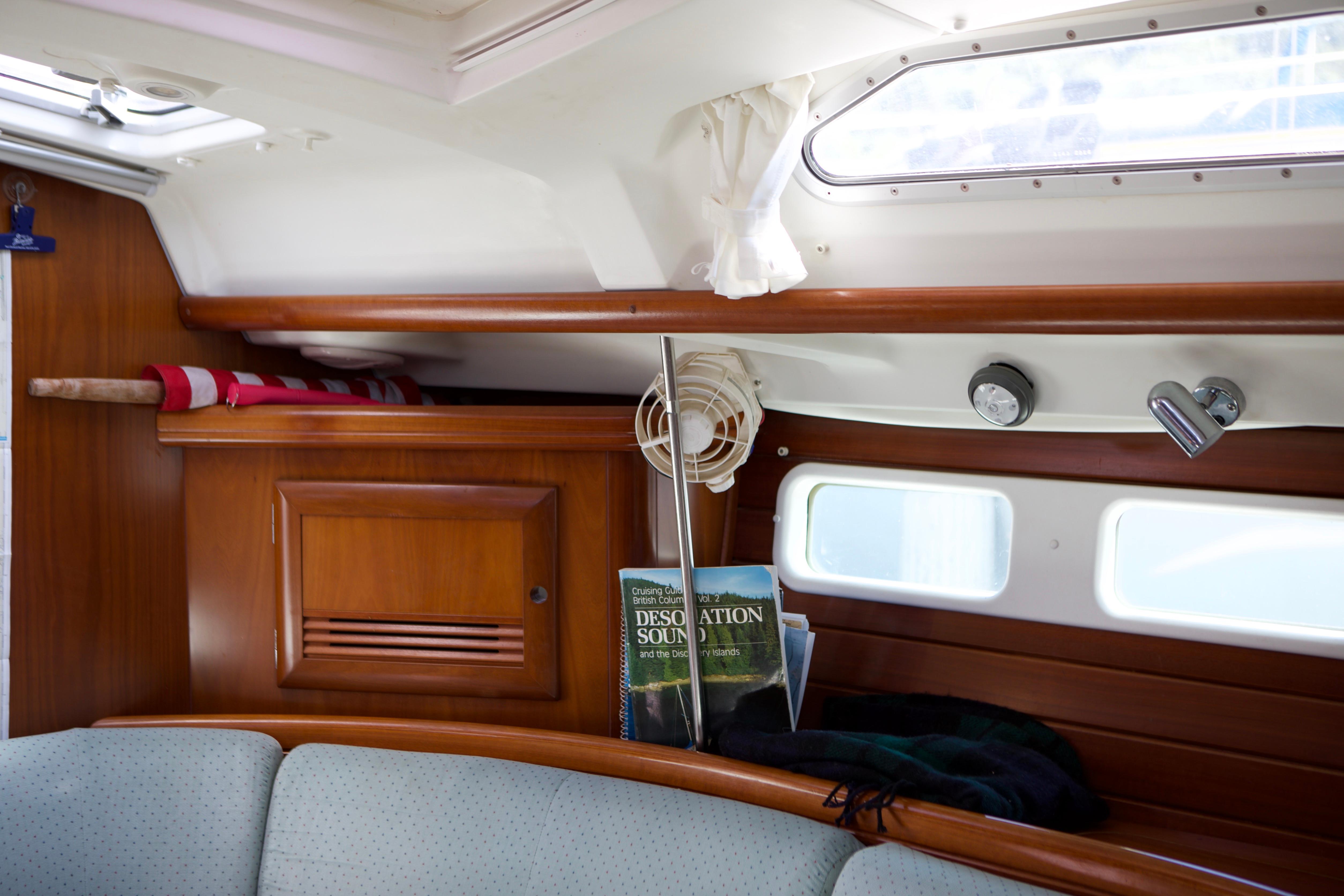 Interior of a 2005 Beneteau 423 sailboat with wooden cabinetry and seating.