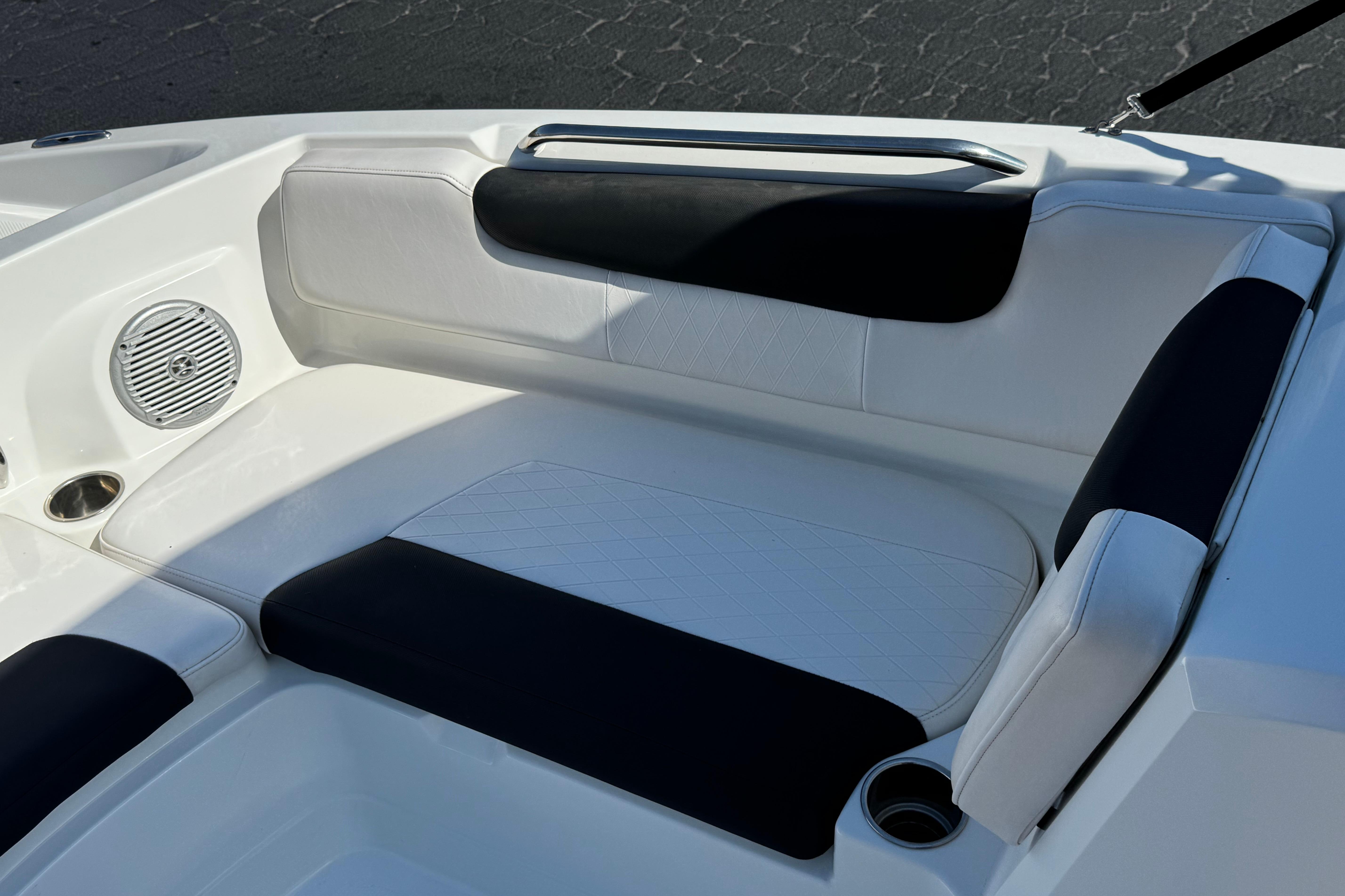 2019 Tahoe 2150 boat interior with white and black seating, cup holder, and speaker.