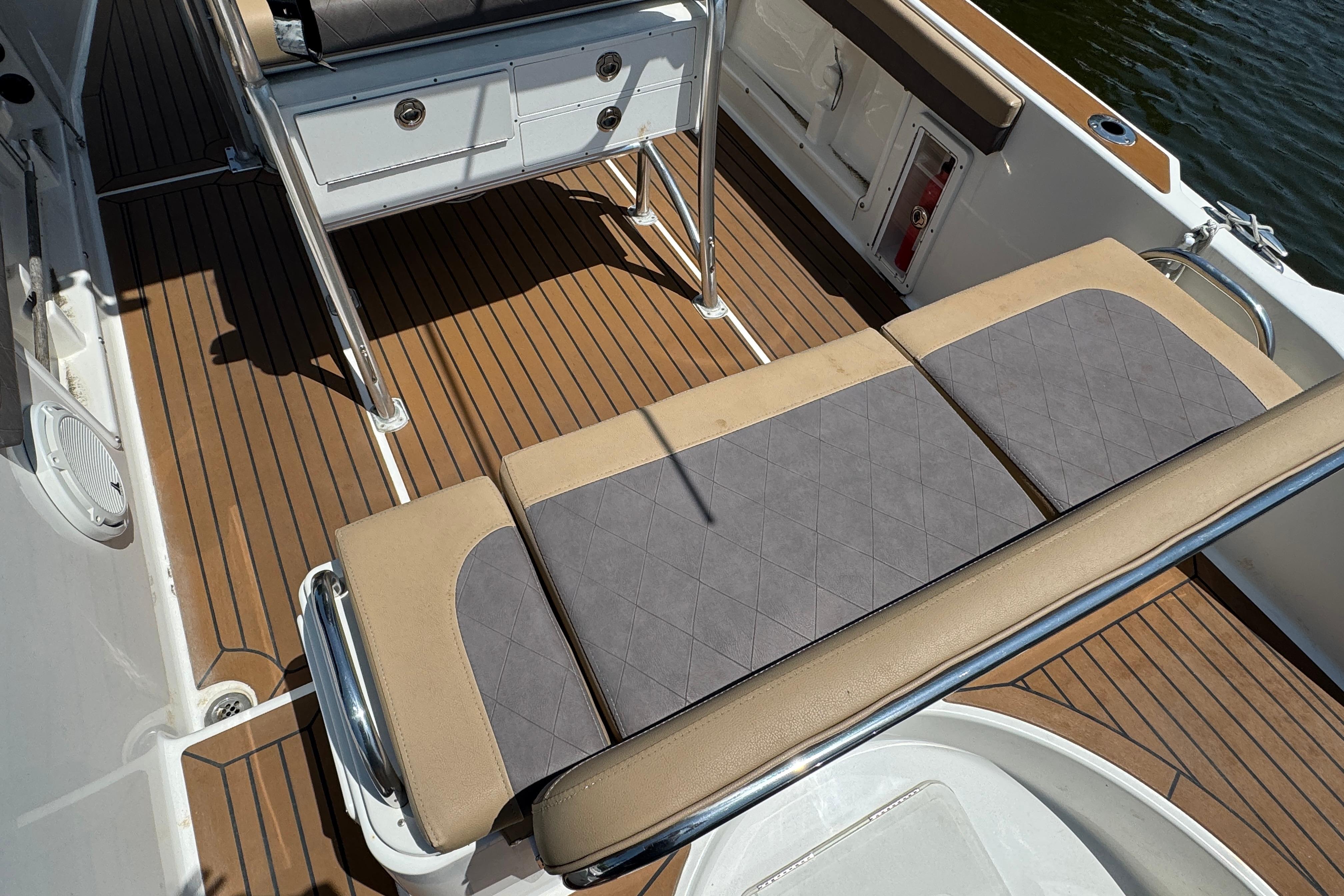2014 Century 2301 Center Console boat interior with cushioned seating and teak flooring.