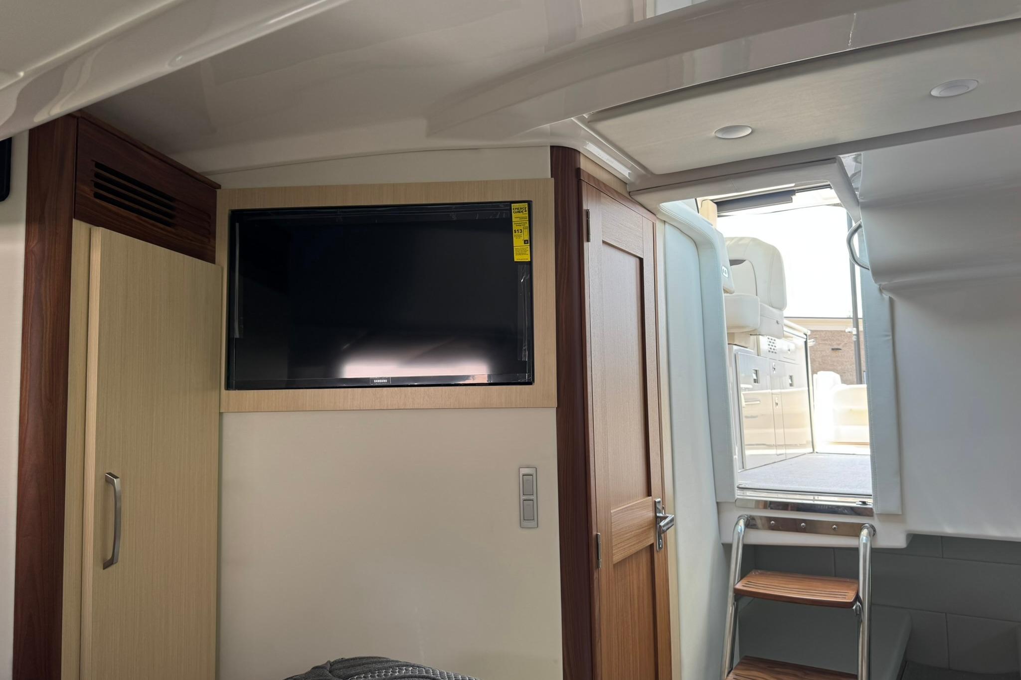 Interior of 2026 Regal 36 Grande Coupe with TV and wooden cabinetry.