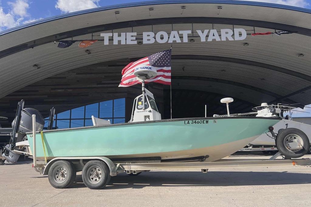 1997 Gravois 20CC boat on trailer at The Boat Yard, American flag displayed.