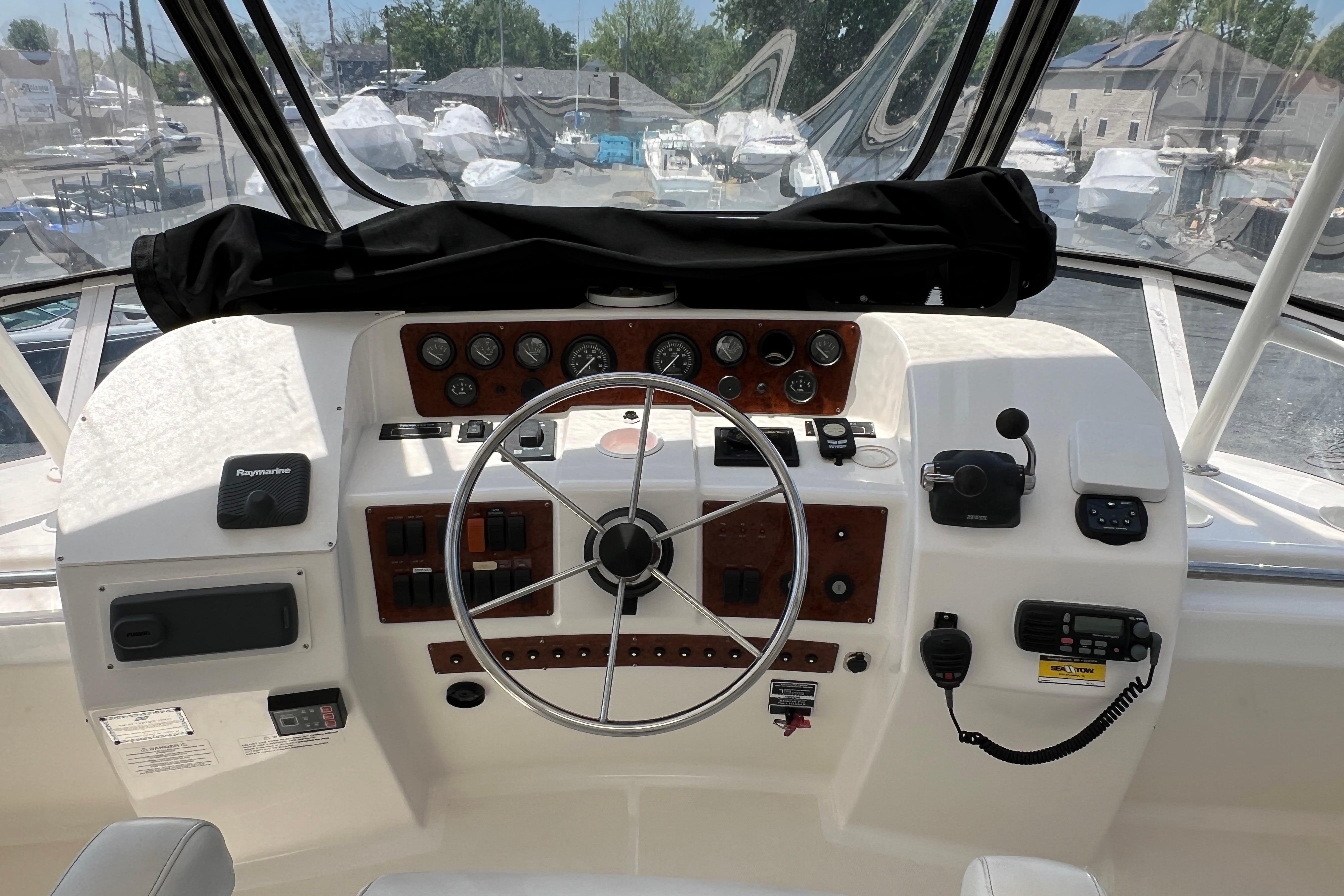 2002 Silverton 453 Motor Yacht helm with steering wheel, gauges, and navigation equipment.