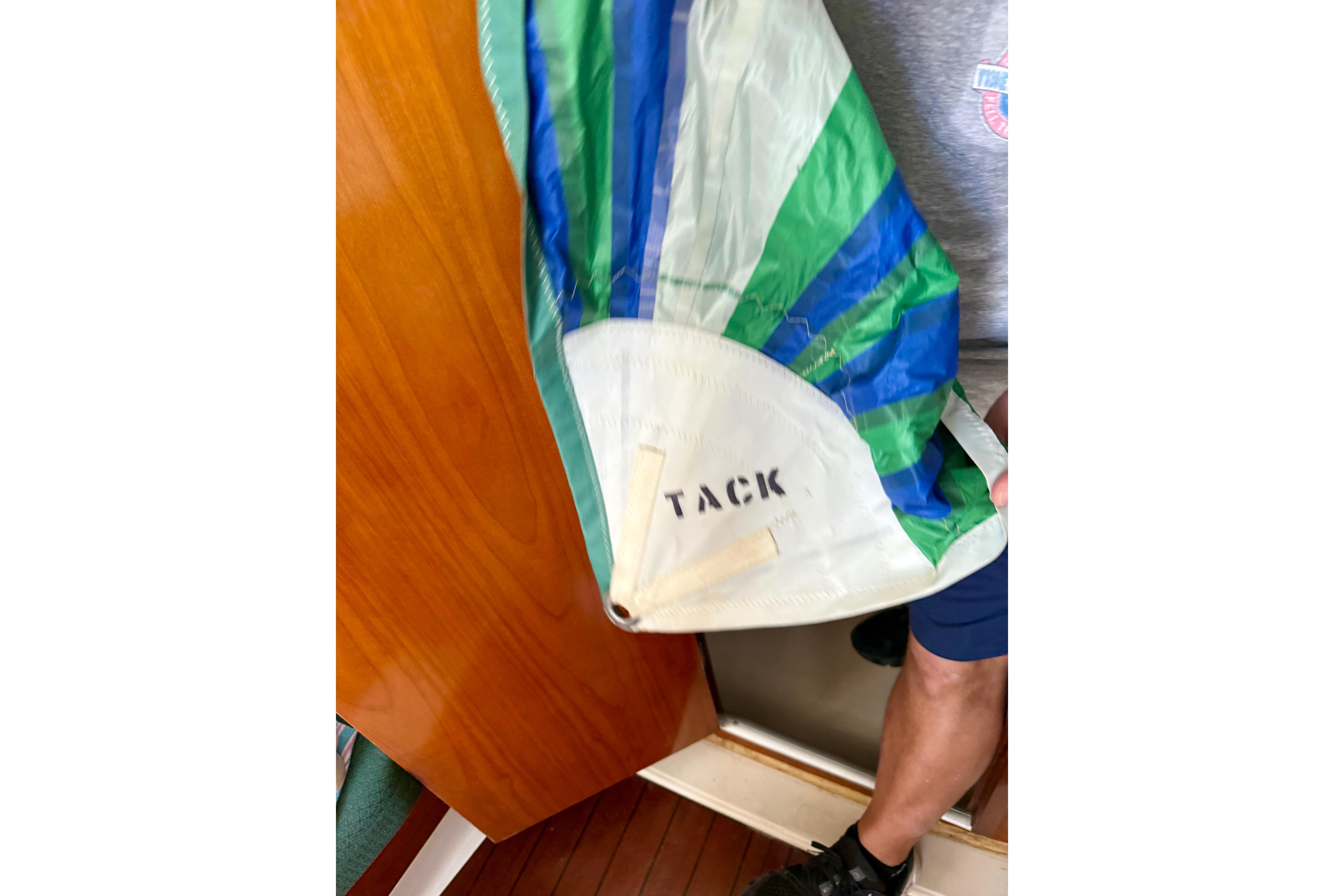 Colorful sail labeled "TACK" on a 2002 Beneteau Oceanis Clipper 311 yacht.