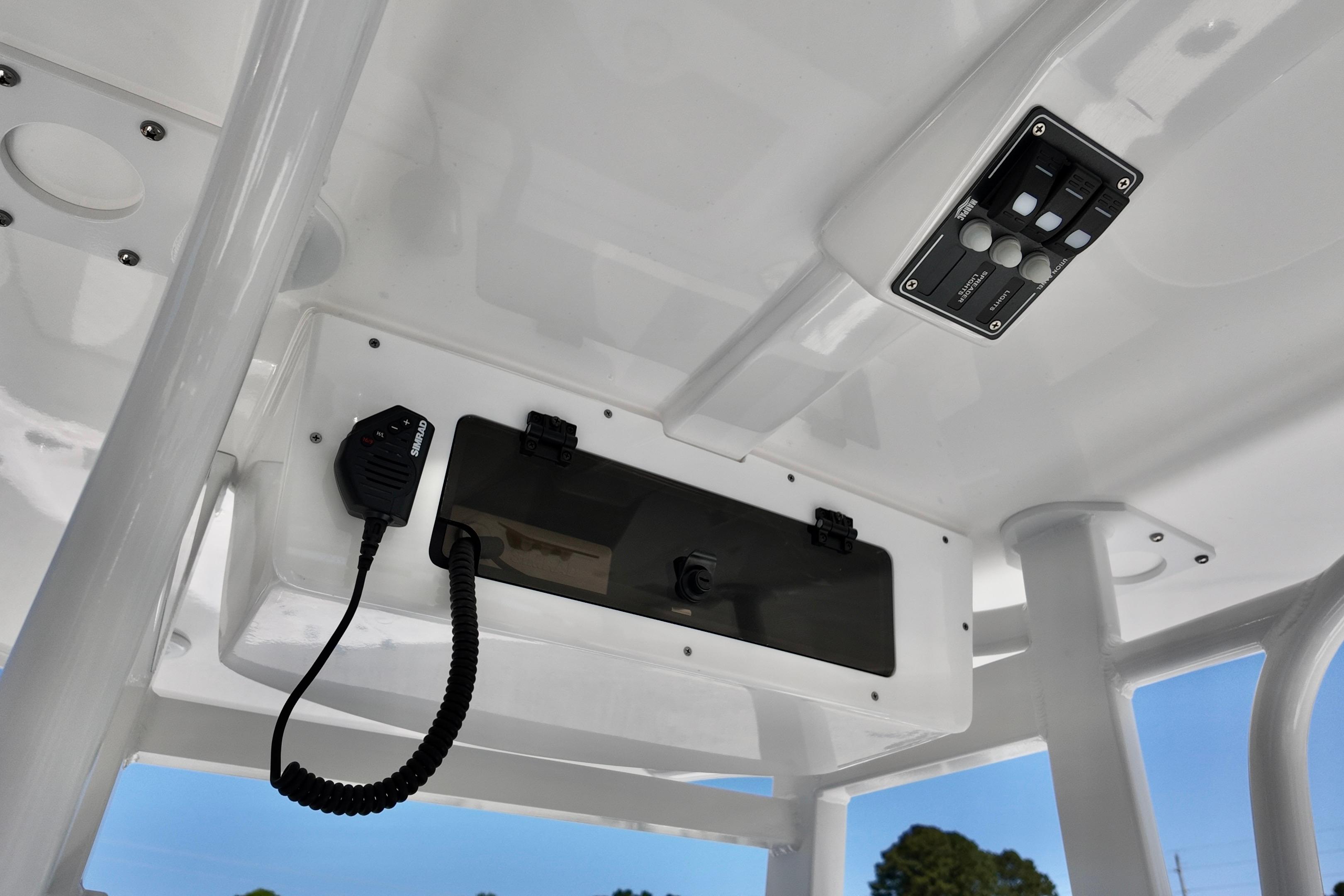 2026 NauticStar 251 Hybrid boat console with radio and control panel.