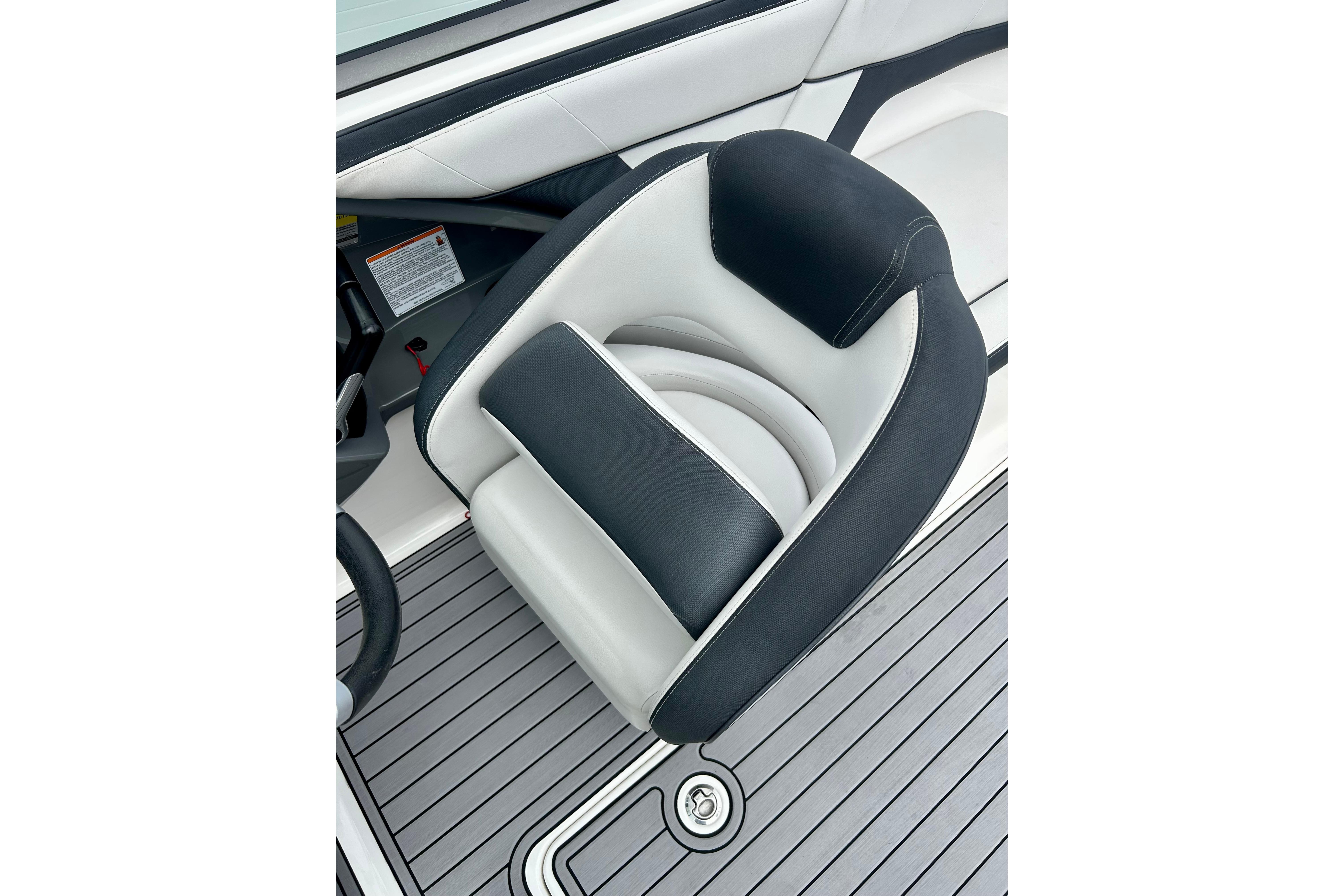 2015 Yamaha Boats AR210 seat with sleek black and white design on deck.