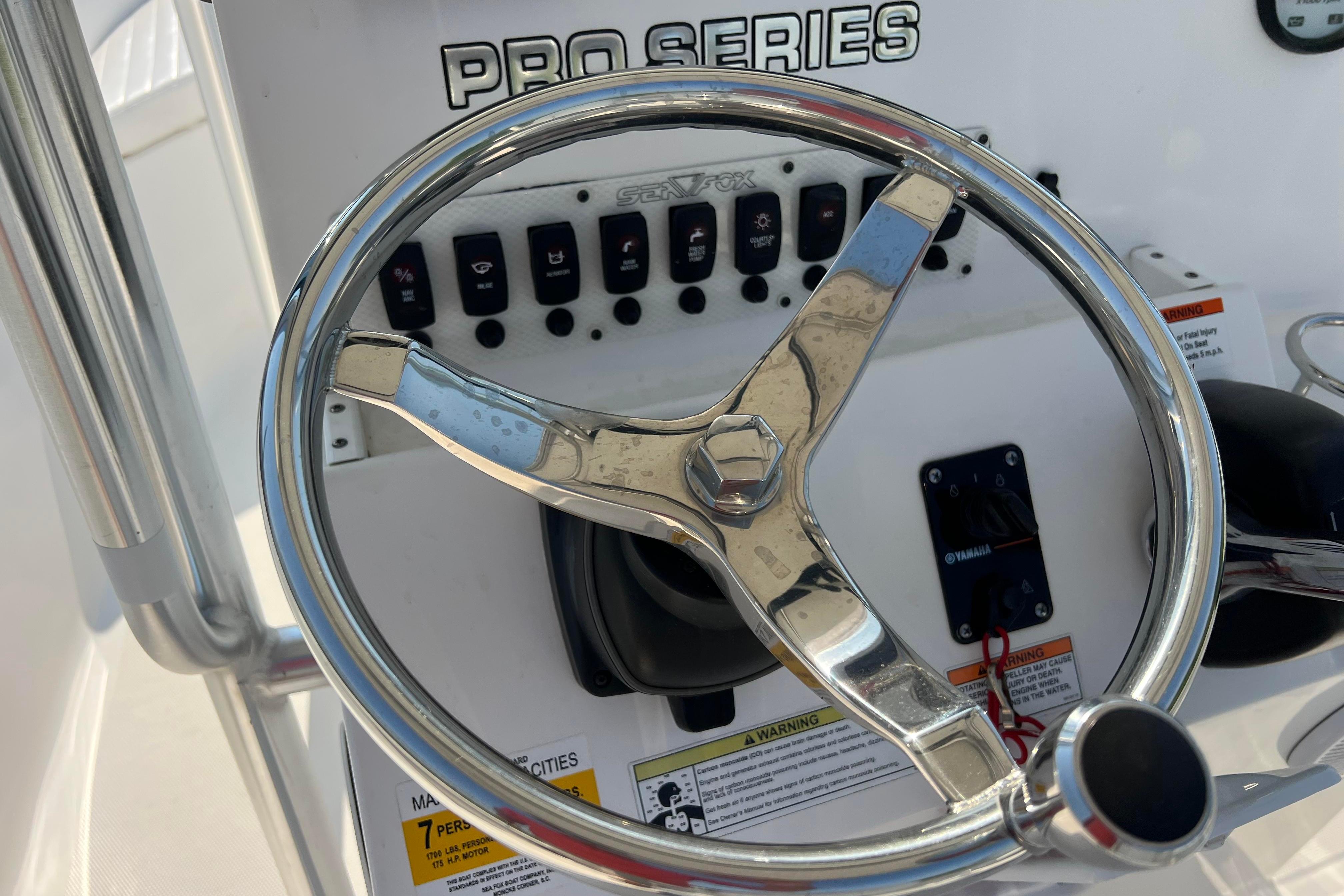 Steering wheel and controls of a 2012 Sea Fox 206 Center Console boat.