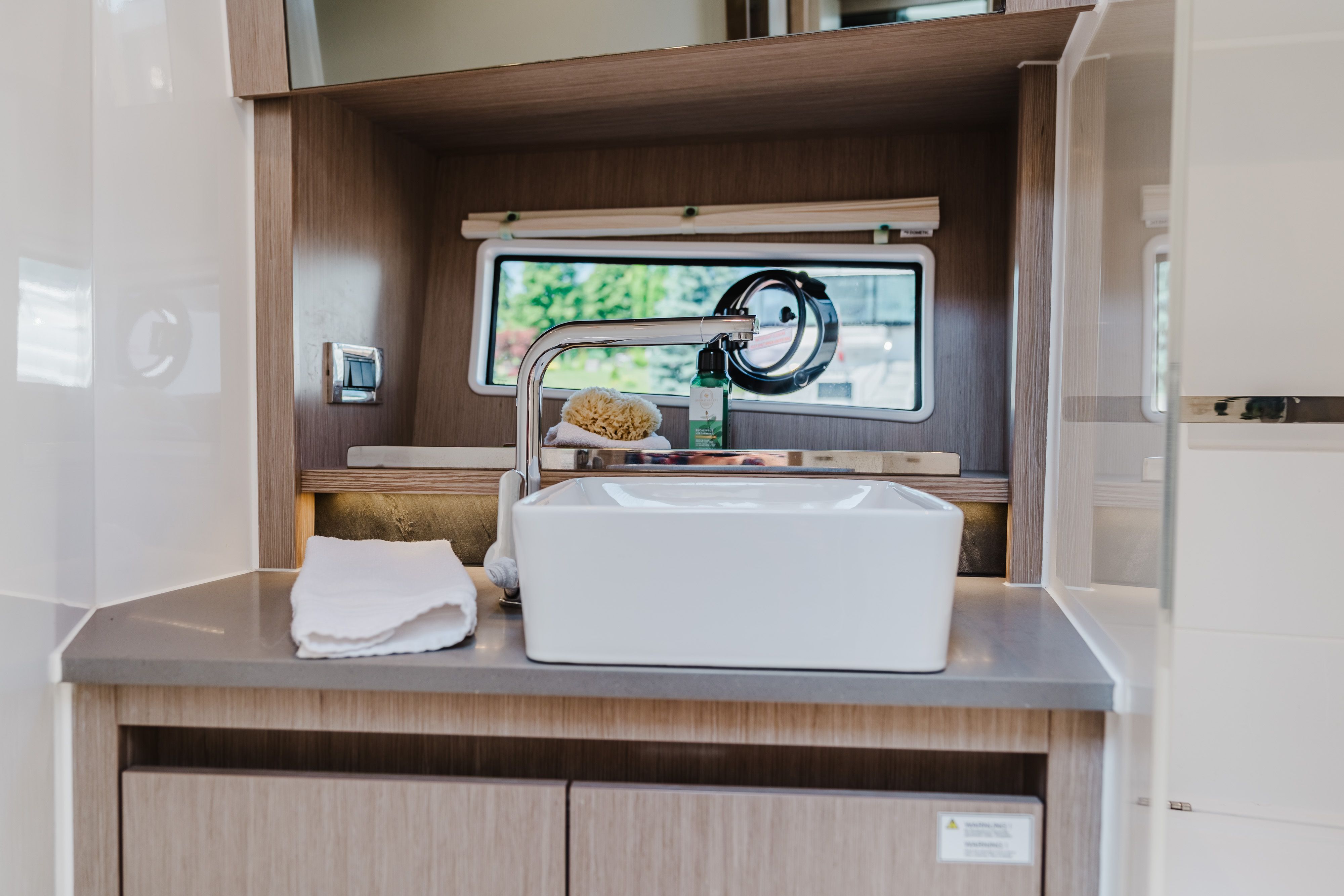 Sink and window in a modern boat cabin.