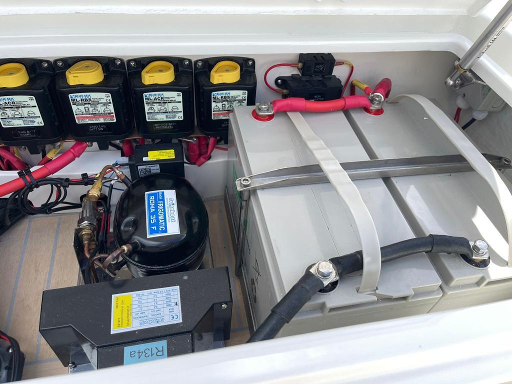 Battery compartment of 2022 Rib-X Chase RIB with multiple batteries and wiring.