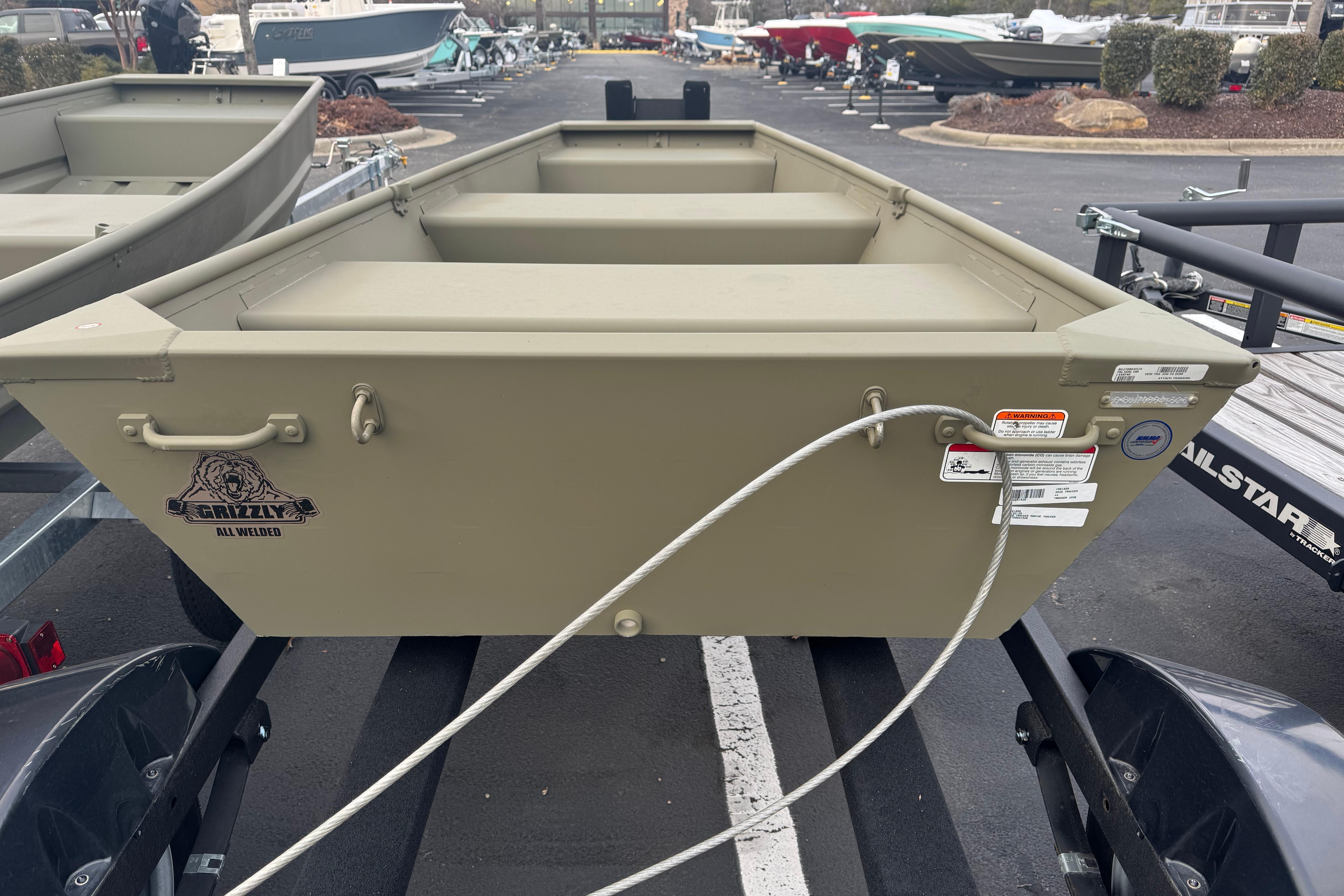 2026 Tracker Grizzly 10 Jon boat on trailer in parking lot.