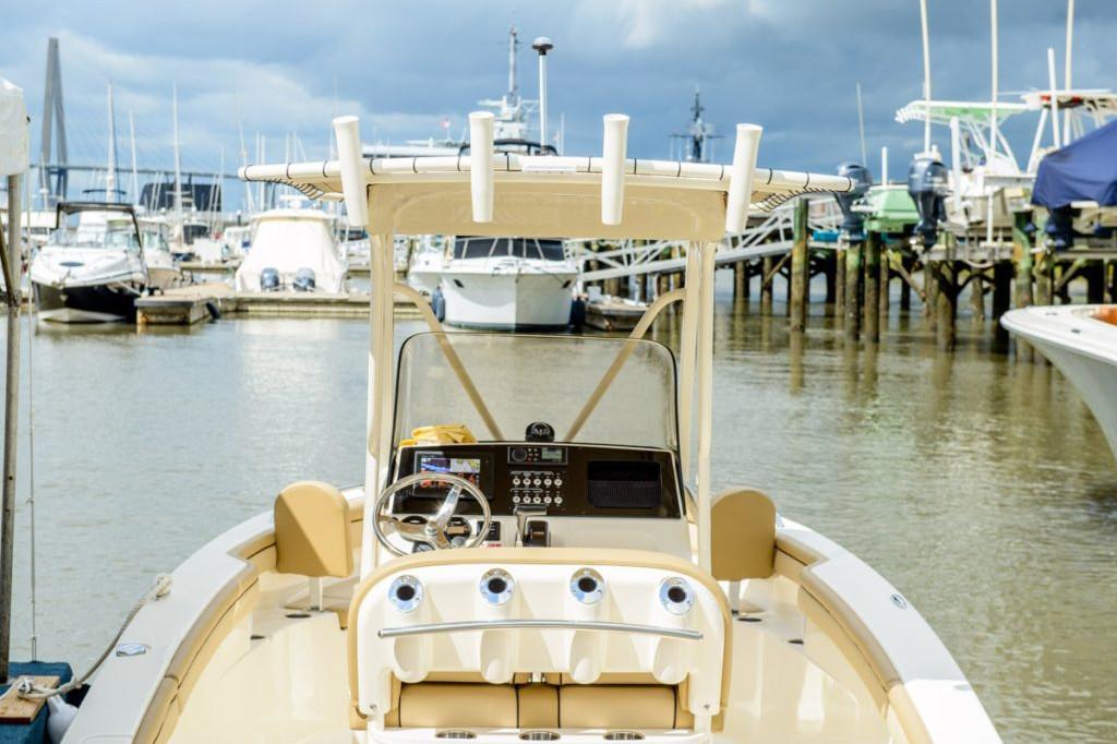 Manufacturer Provided Image: 2025 Scout 215 XSF boat docked in a marina under cloudy skies.