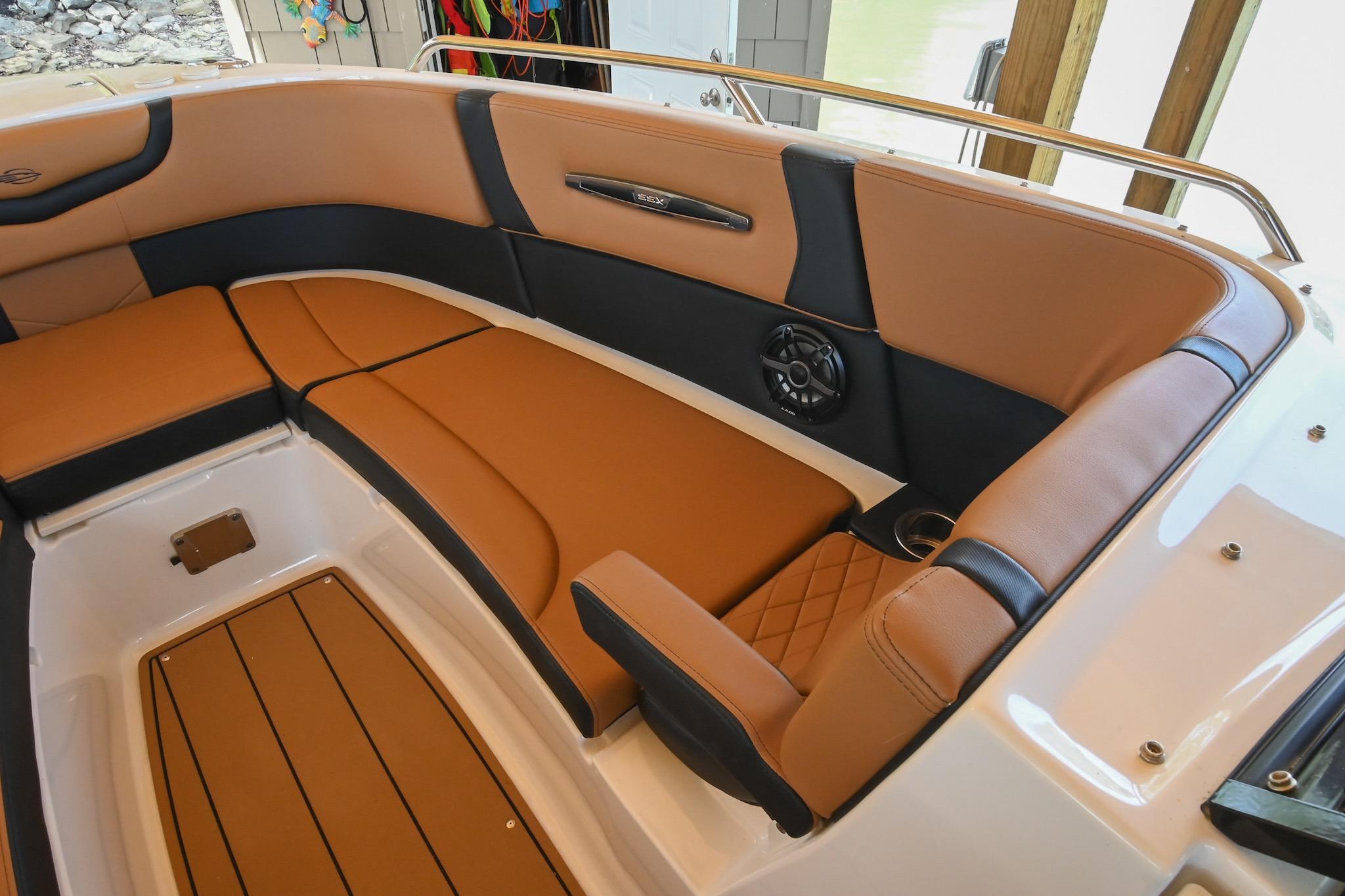 Luxurious interior of 2022 Chaparral 307 SSX boat with tan and black seating.