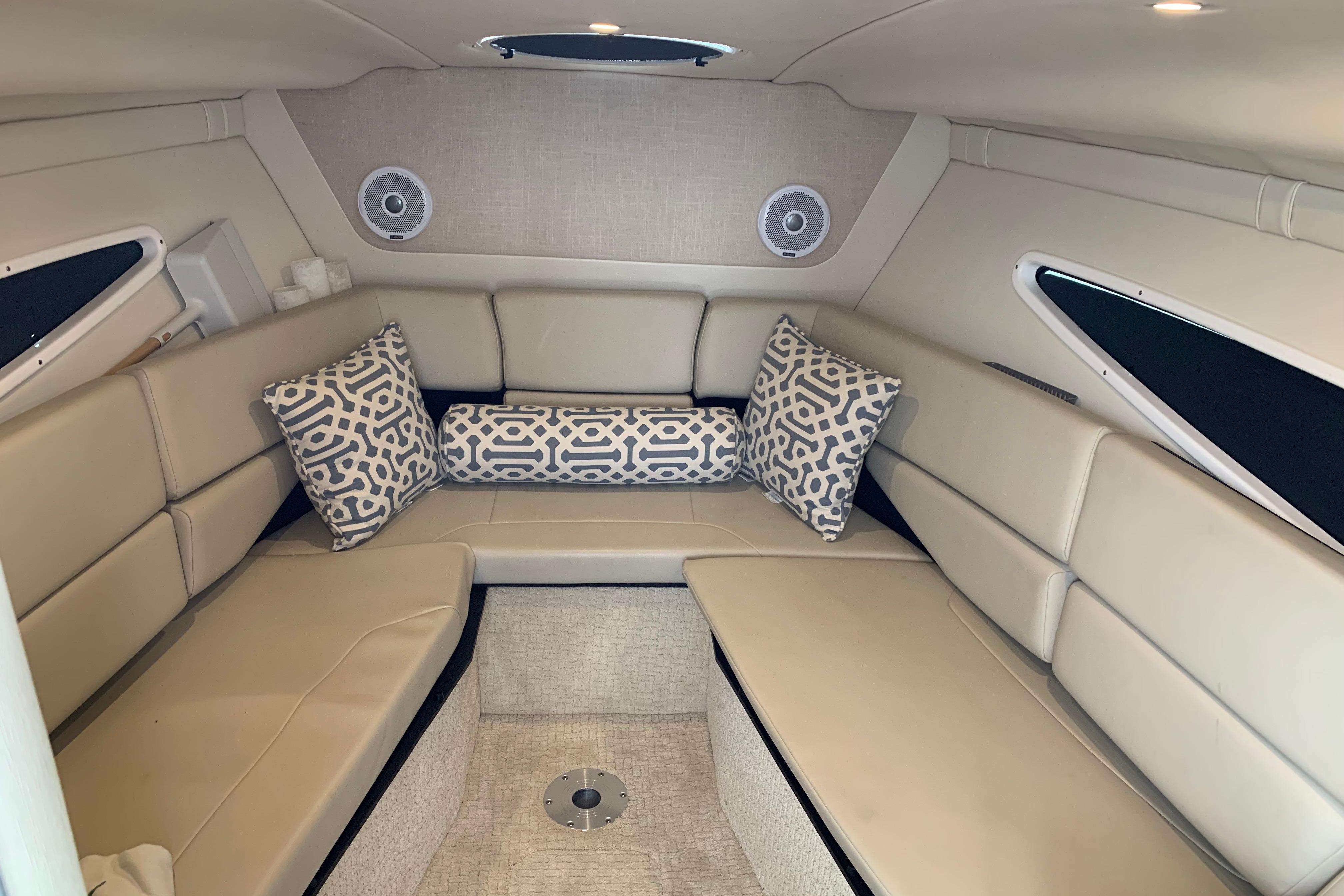 Interior cabin of a 2017 Regal 26 Express boat with beige seating and patterned cushions.