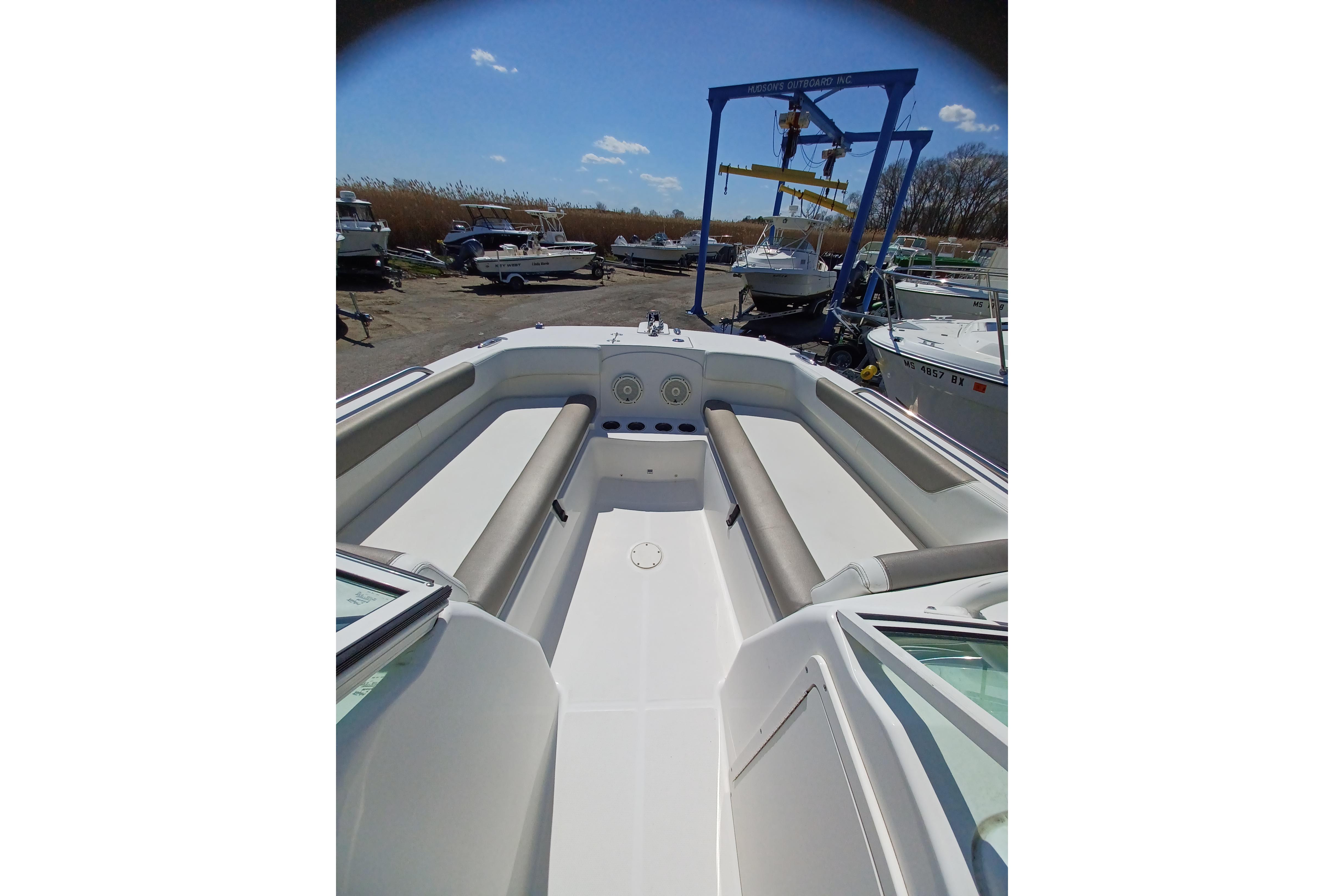 2020 World Cat 230 DC boat interior with seating, docked outdoors.