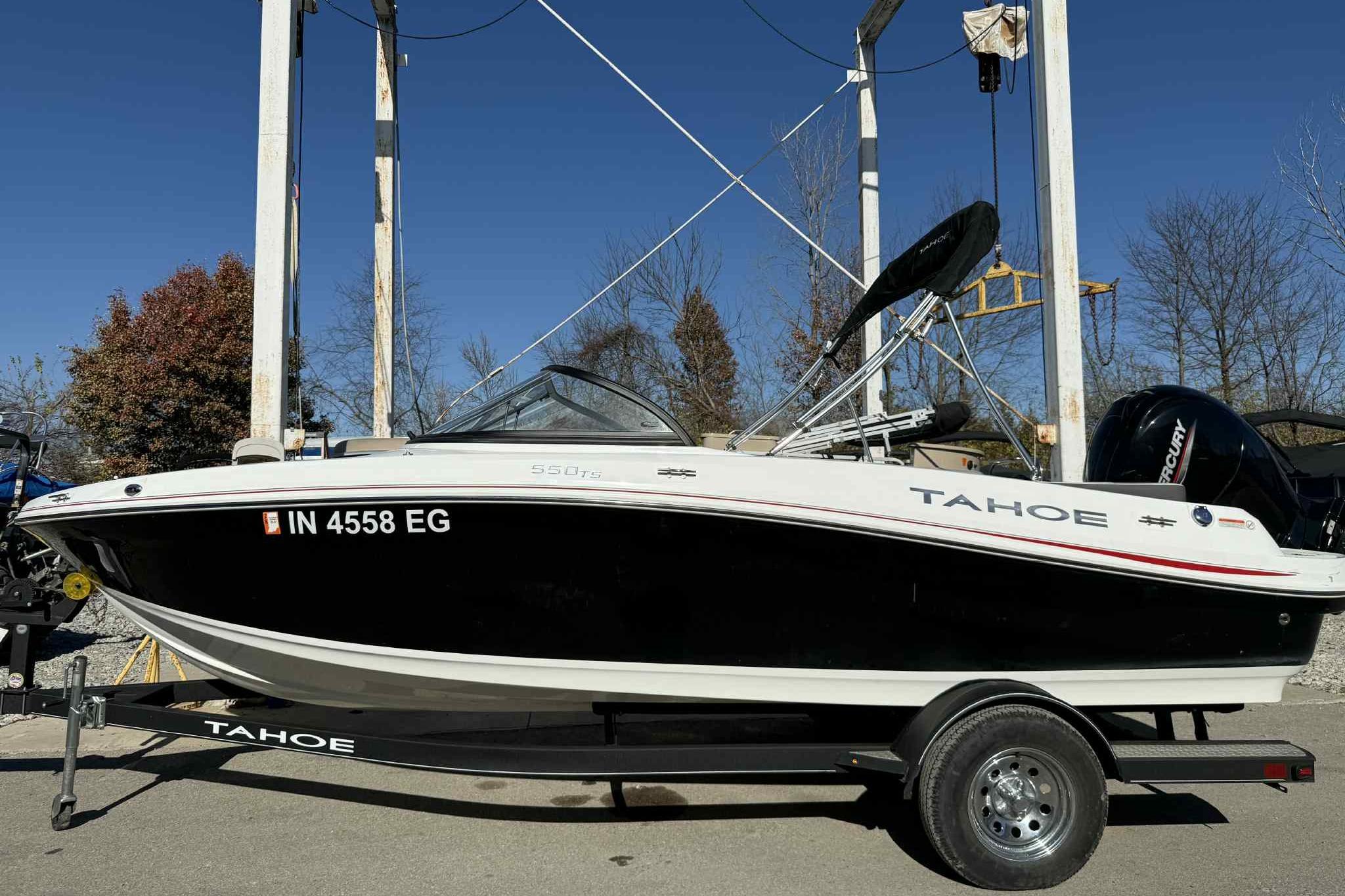 2021 Tahoe 550 TS boat on trailer, displayed outdoors under clear blue sky.